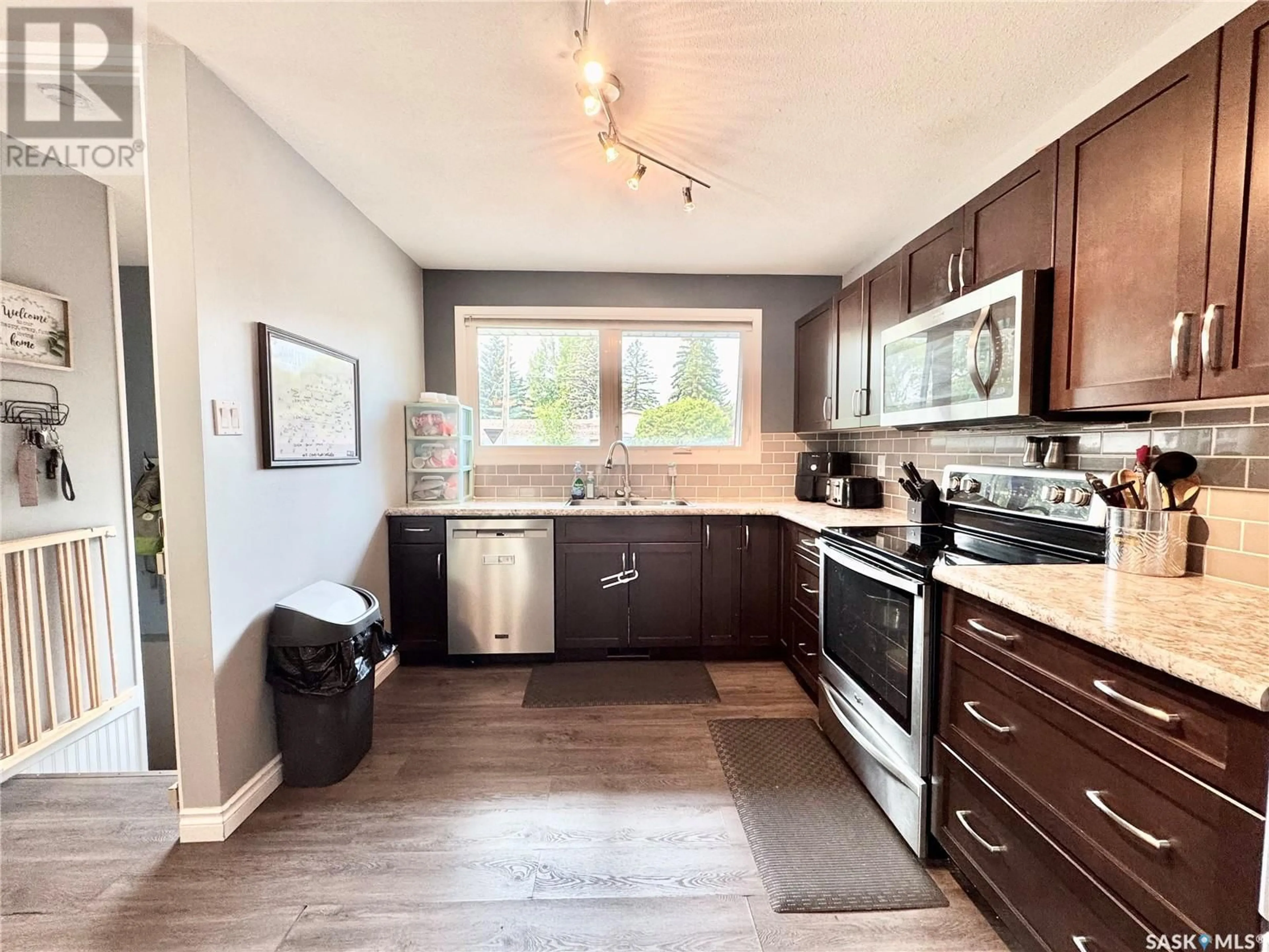 Open concept kitchen, wood/laminate floor for 2505 MCDONALD AVENUE, Prince Albert Saskatchewan S6V2V7