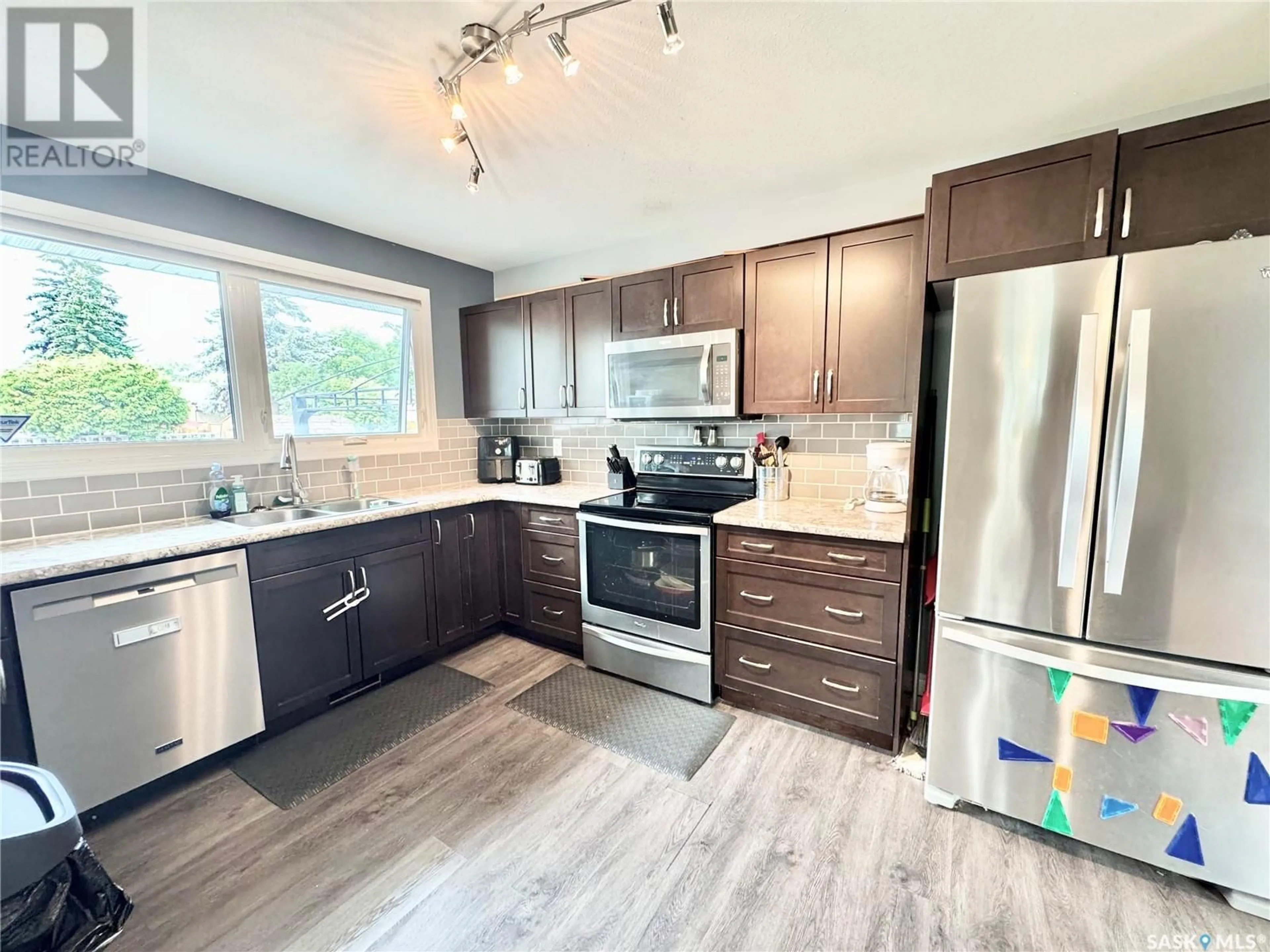 Open concept kitchen, wood/laminate floor for 2505 MCDONALD AVENUE, Prince Albert Saskatchewan S6V2V7