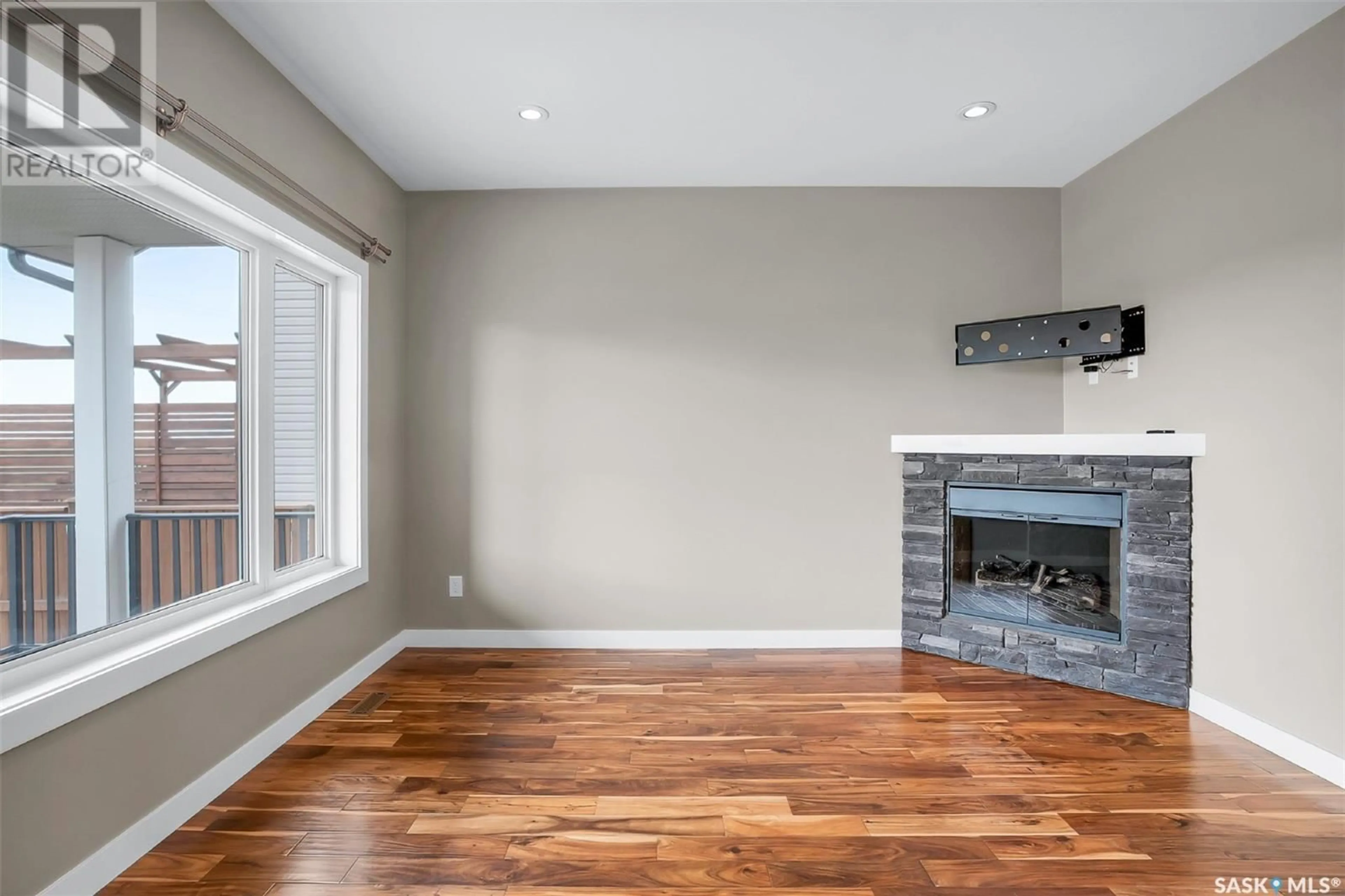 Living room with furniture, wood/laminate floor for 429 REDWOOD CRESCENT, Warman Saskatchewan S0K4S0