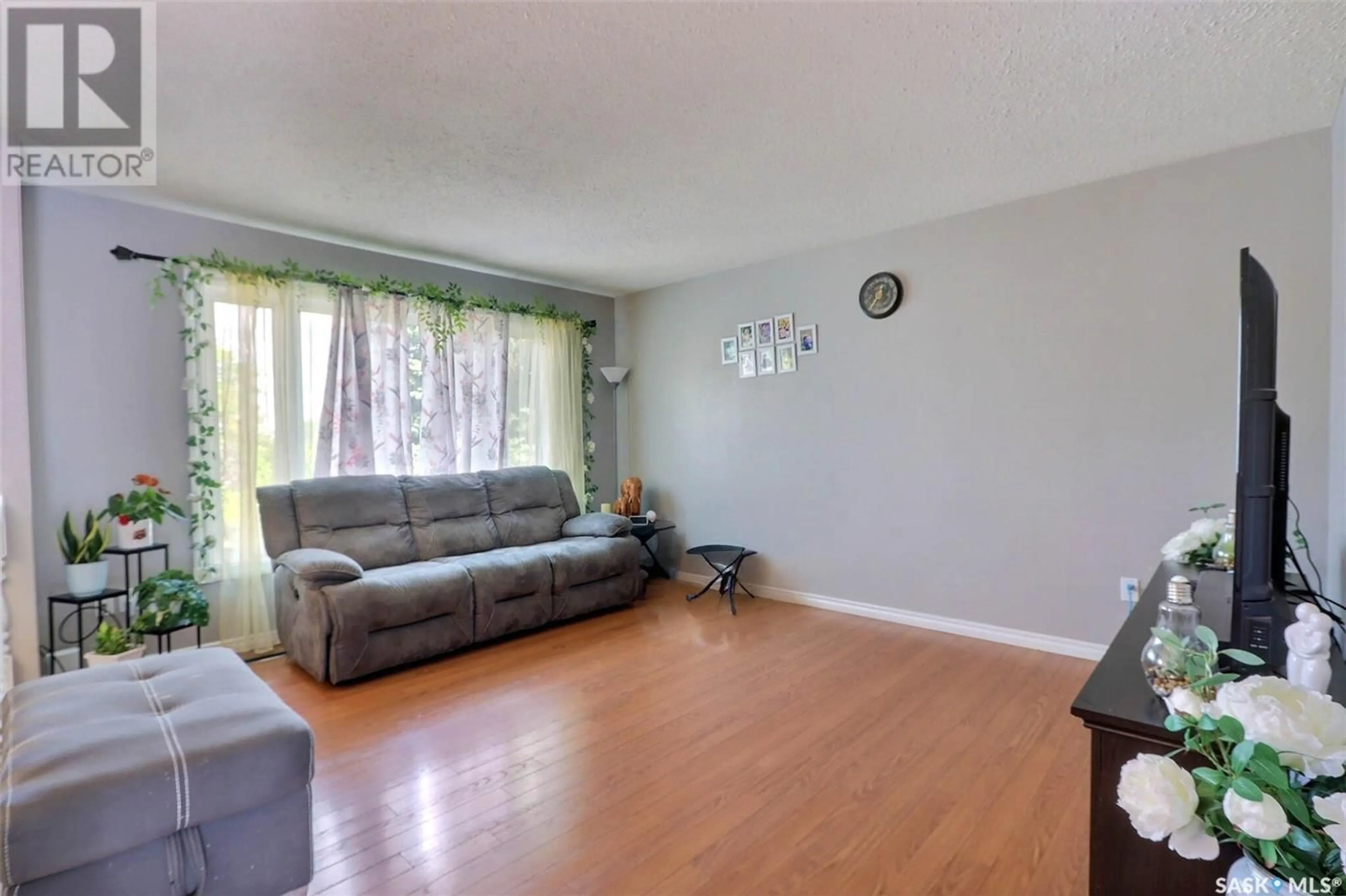 Living room with furniture, wood/laminate floor for 1699 ALLBRIGHT CRESCENT, Prince Albert Saskatchewan S6V7C3
