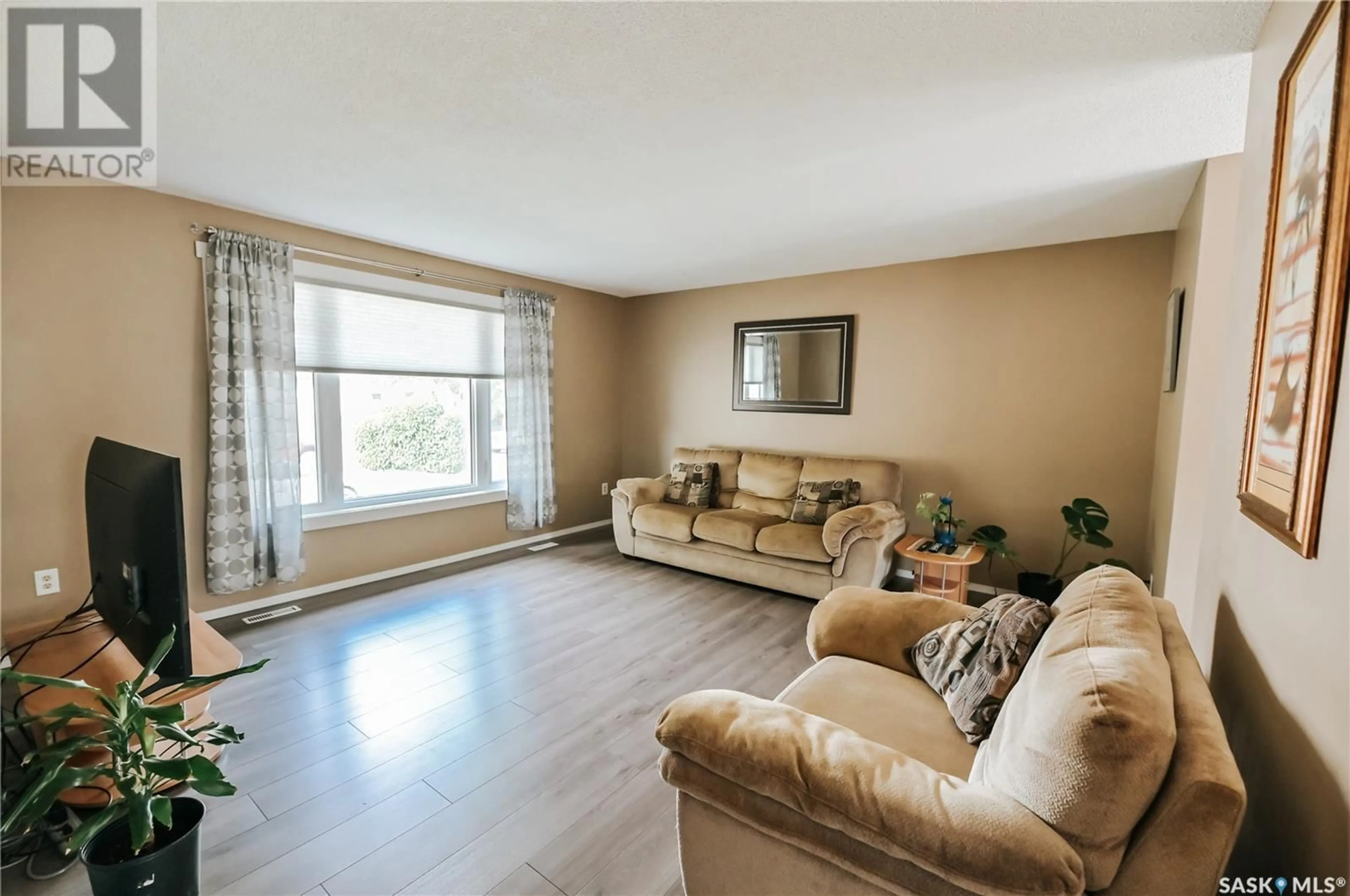 Living room with furniture, wood/laminate floor for 1661 OLIVE DIEFENBAKER DRIVE, Prince Albert Saskatchewan S6V7V9
