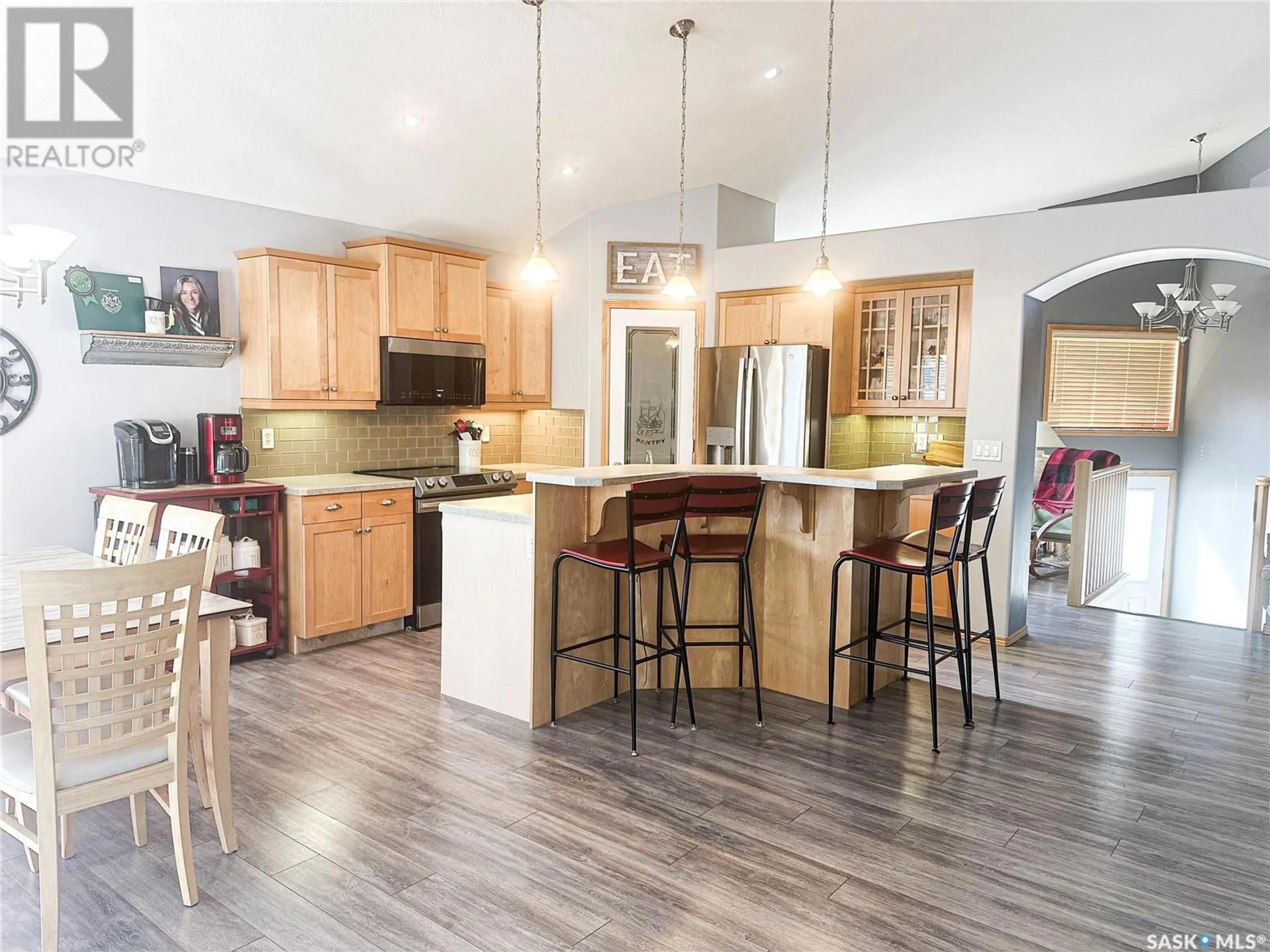 Open concept kitchen, wood/laminate floor for 8002 KNOX PLACE, Regina Saskatchewan S4Y1G5