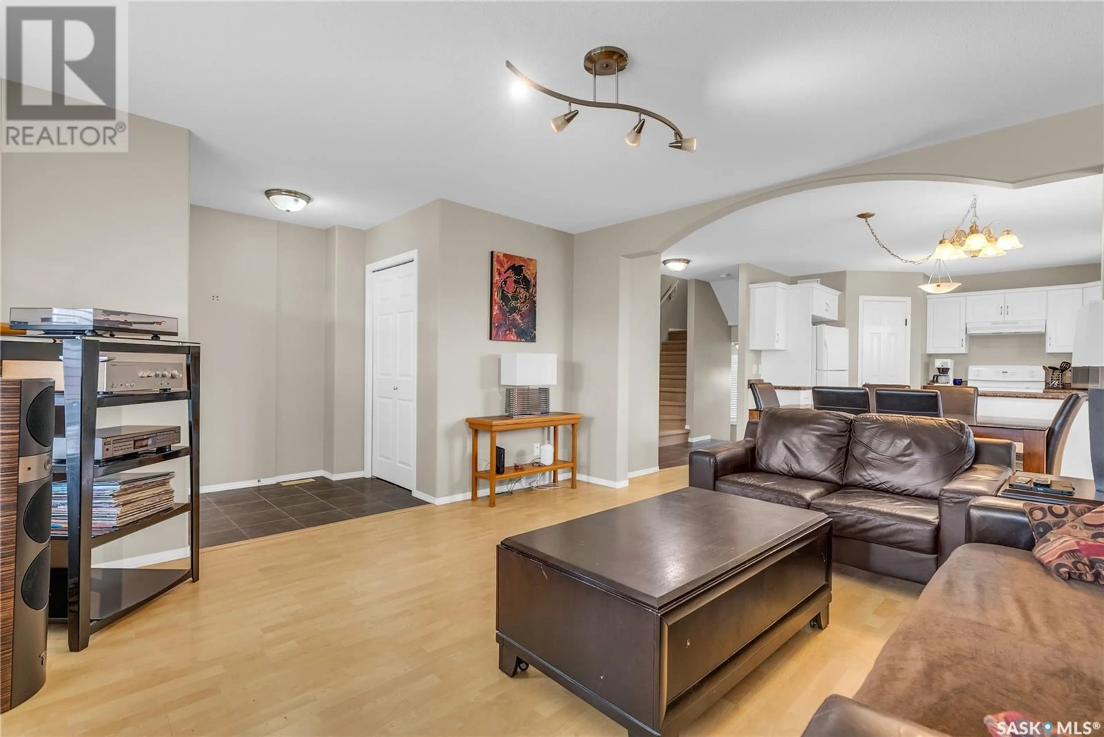Living room with furniture, wood/laminate floor for 403 RUTHERFORD CRESCENT, Saskatoon Saskatchewan S7N4X7