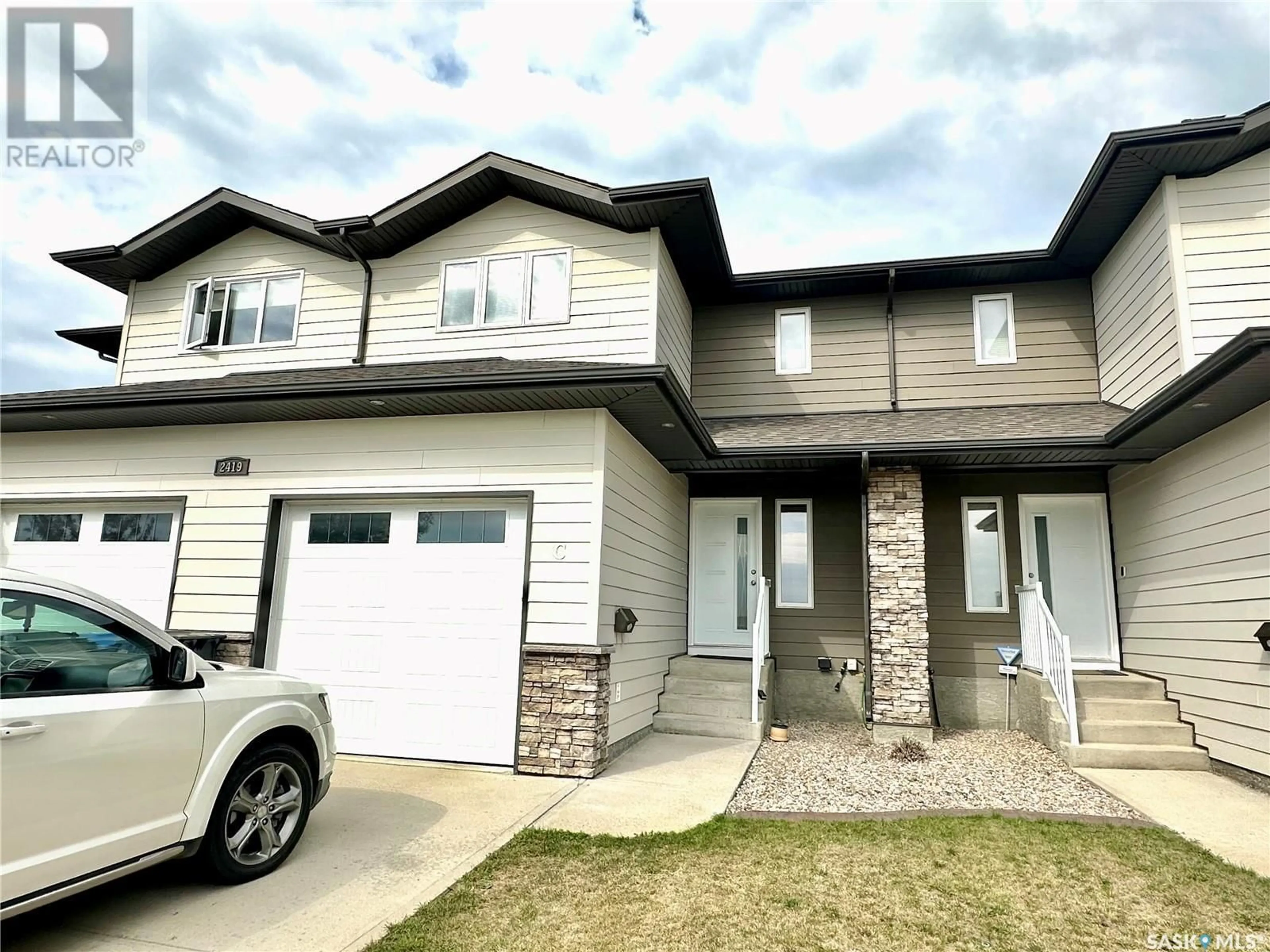 Home with vinyl exterior material, street for 2419 HENDERSON DRIVE, North Battleford Saskatchewan S9A0Y3