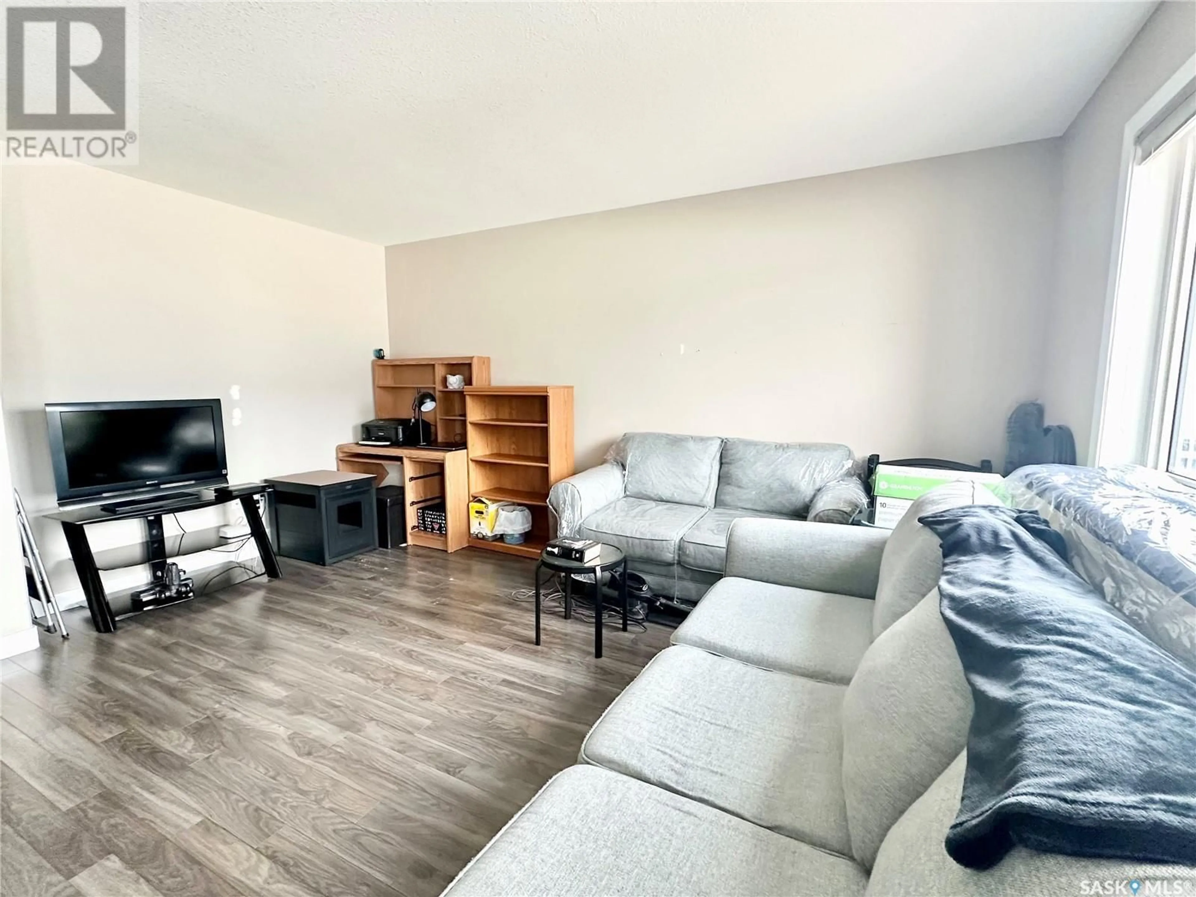 Living room with furniture, wood/laminate floor for 2419 HENDERSON DRIVE, North Battleford Saskatchewan S9A0Y3