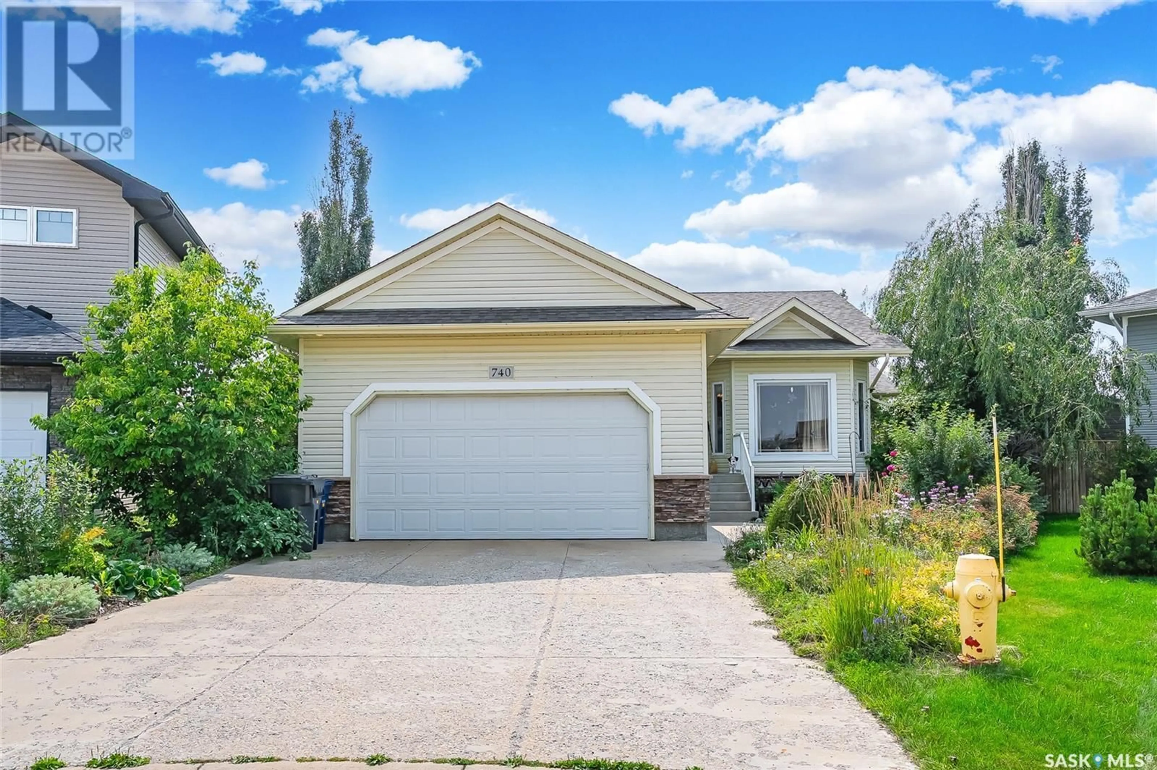 Home with vinyl exterior material, street for 740 REDDEKOPP DRIVE, Martensville Saskatchewan S0K2T2