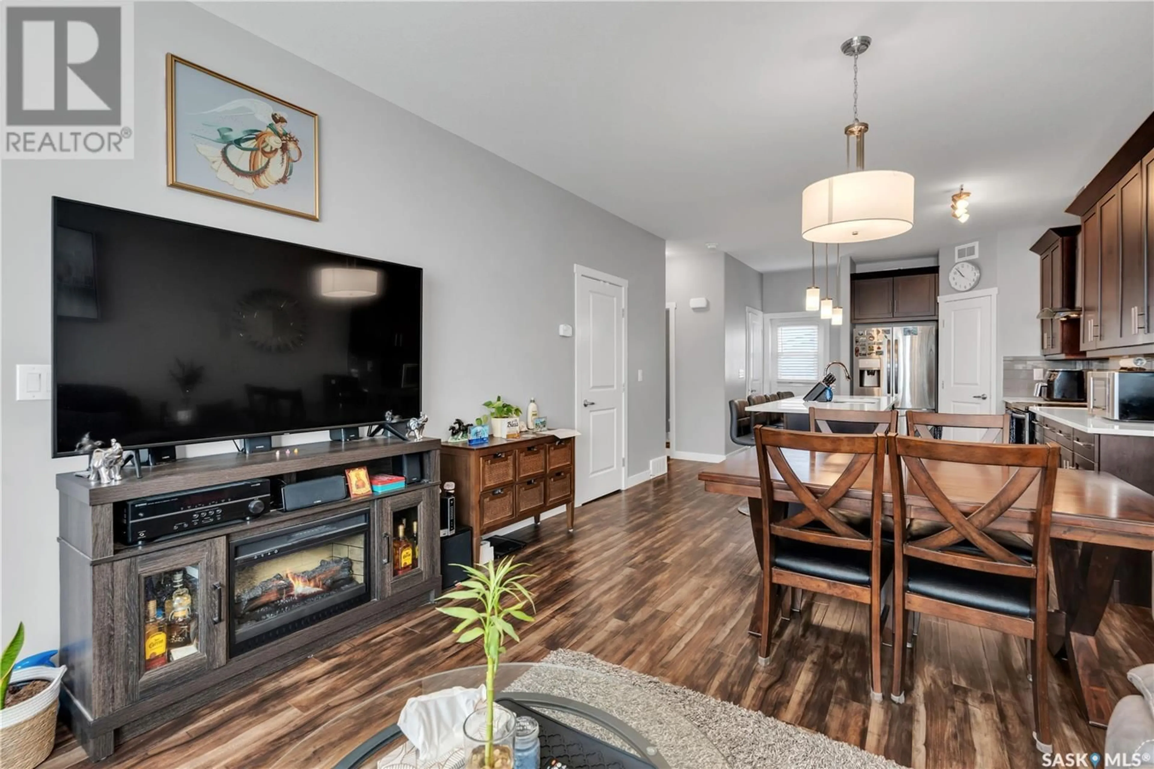 Living room with furniture, wood/laminate floor for 211 1615 RICHARDSON ROAD, Saskatoon Saskatchewan S7R0M7