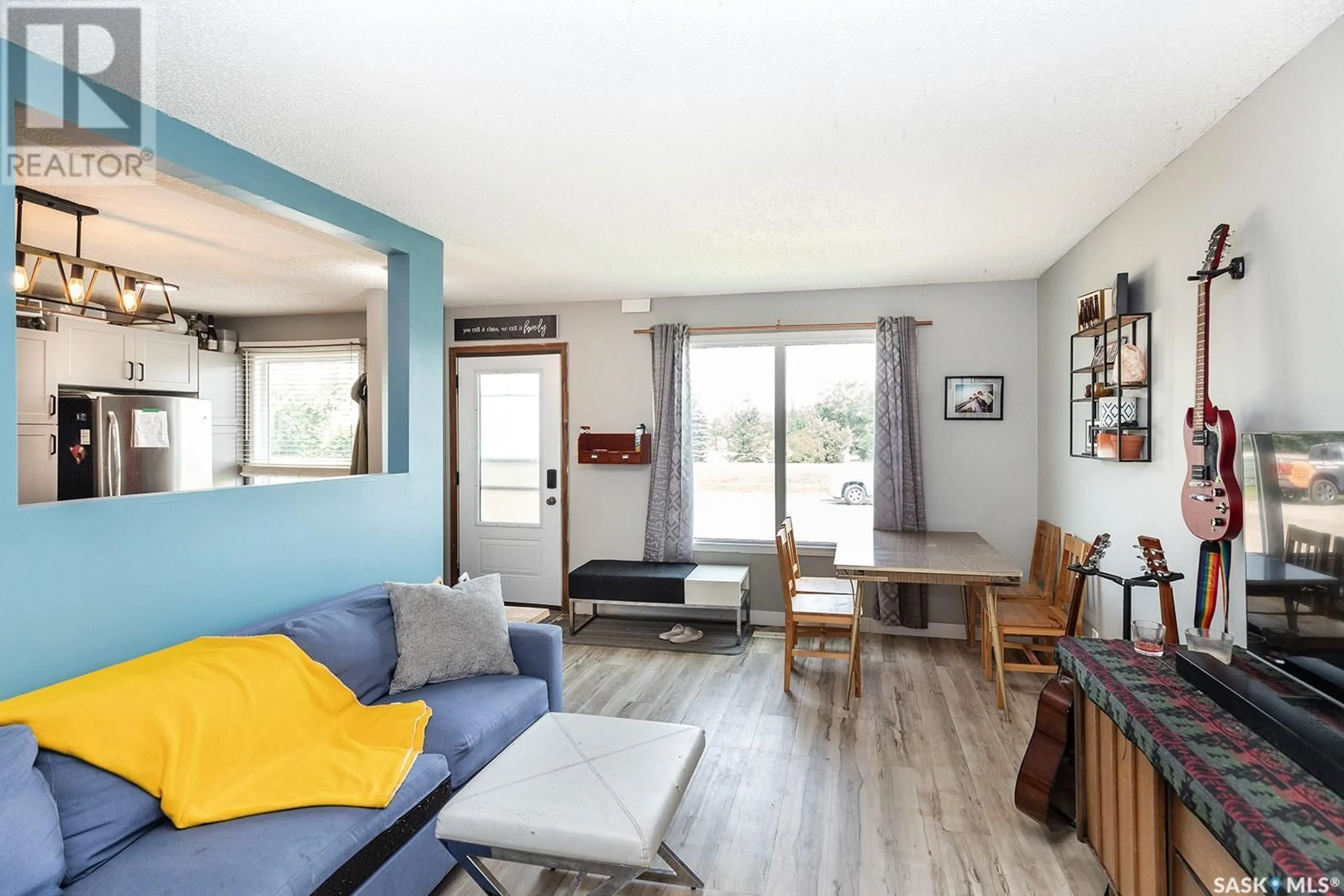 Living room with furniture, wood/laminate floor for A & B - 114 JAMES STREET, Langham Saskatchewan S0K2L0