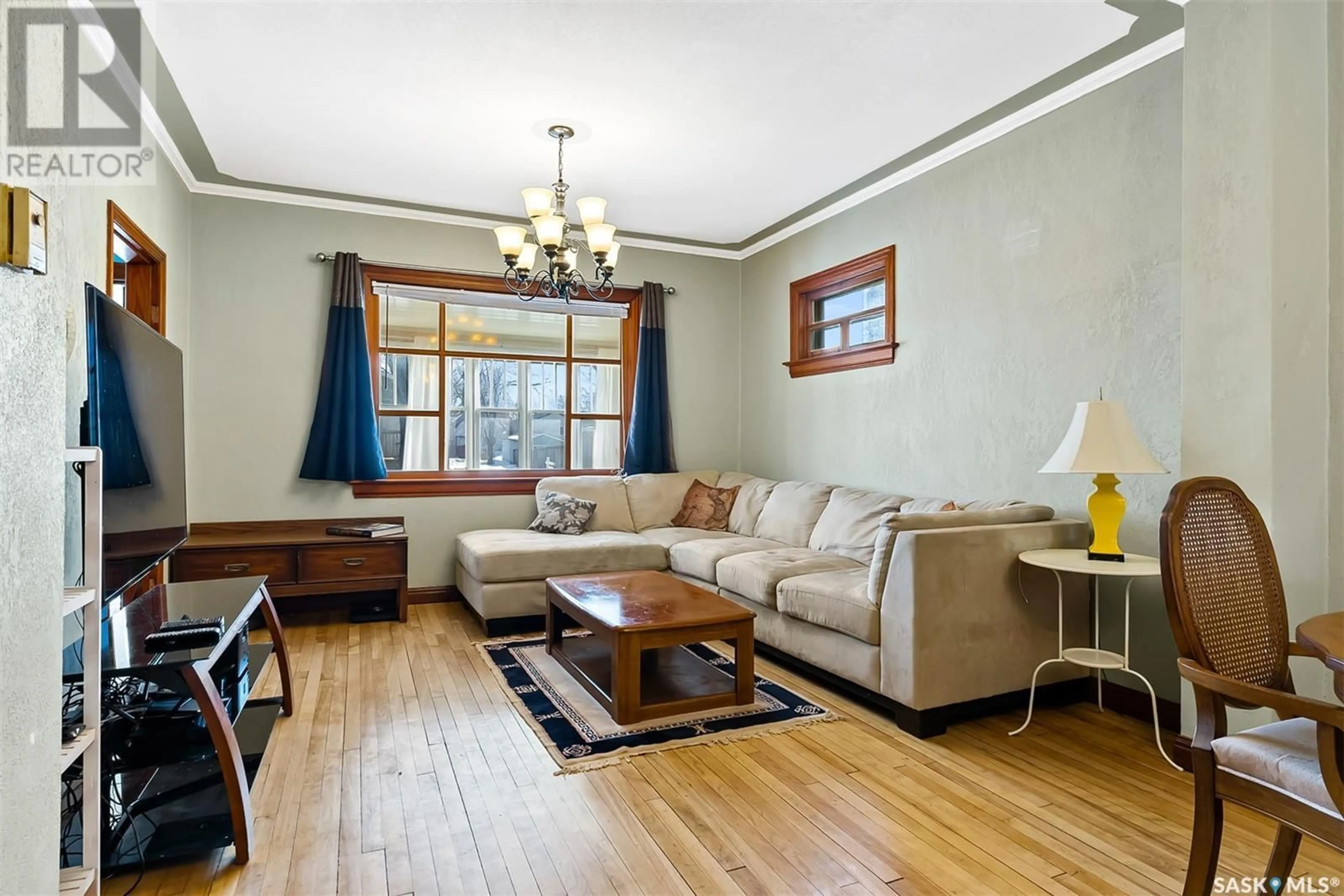 Living room with furniture, wood/laminate floor for 1640 OTTAWA STREET, Regina Saskatchewan S4P1N9