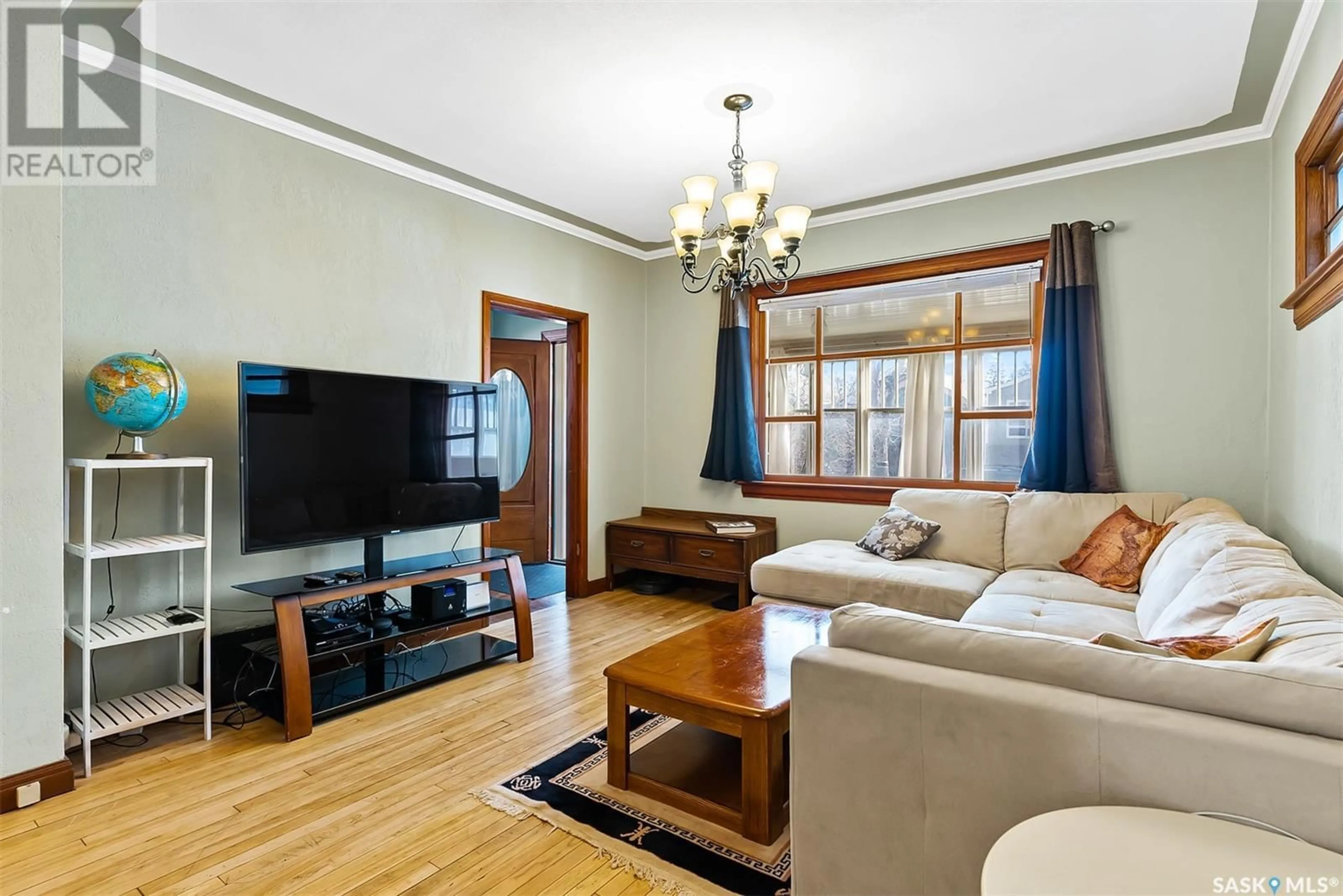 Living room with furniture, wood/laminate floor for 1640 OTTAWA STREET, Regina Saskatchewan S4P1N9
