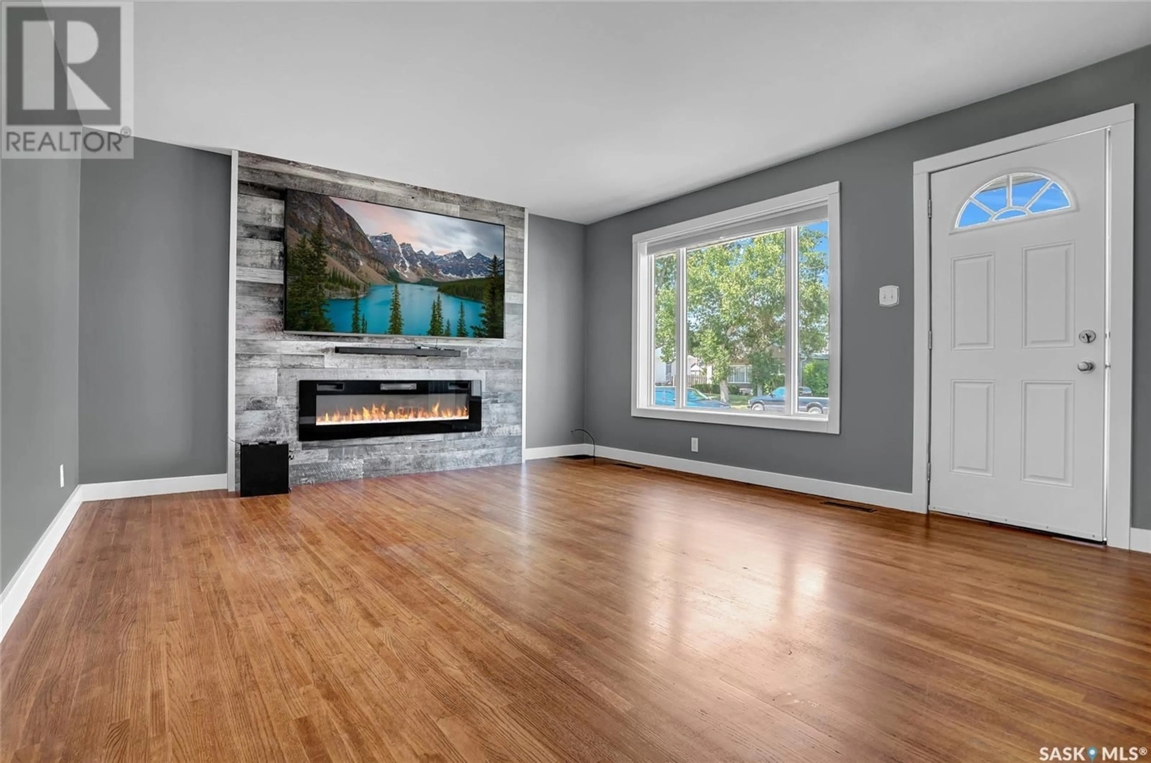 Living room with furniture, wood/laminate floor for 1107 MONTGOMERY STREET, Moose Jaw Saskatchewan S6H2X2