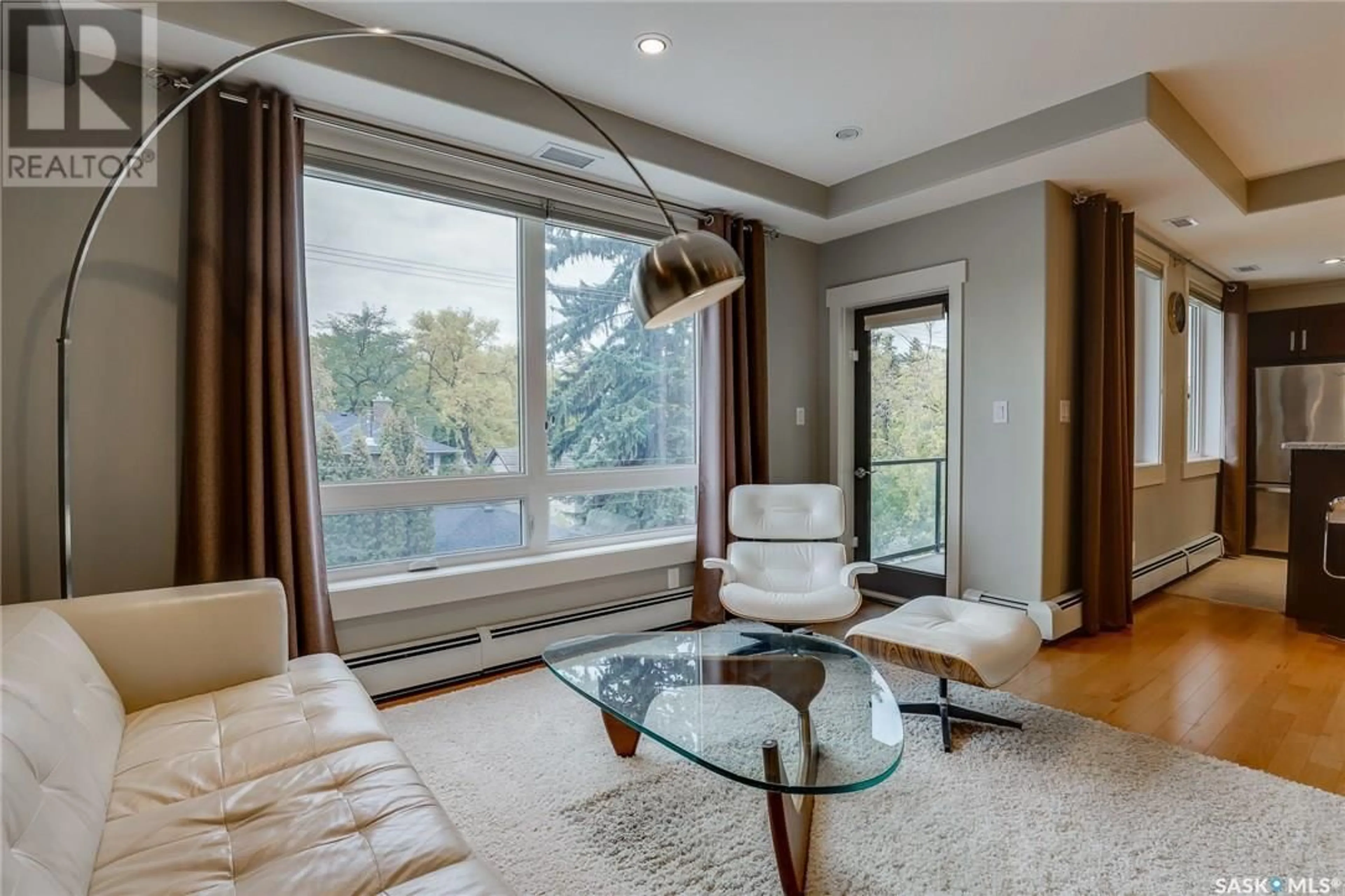 Living room with furniture, wood/laminate floor for 201 - 1132 COLLEGE DRIVE, Saskatoon Saskatchewan S7N0W2