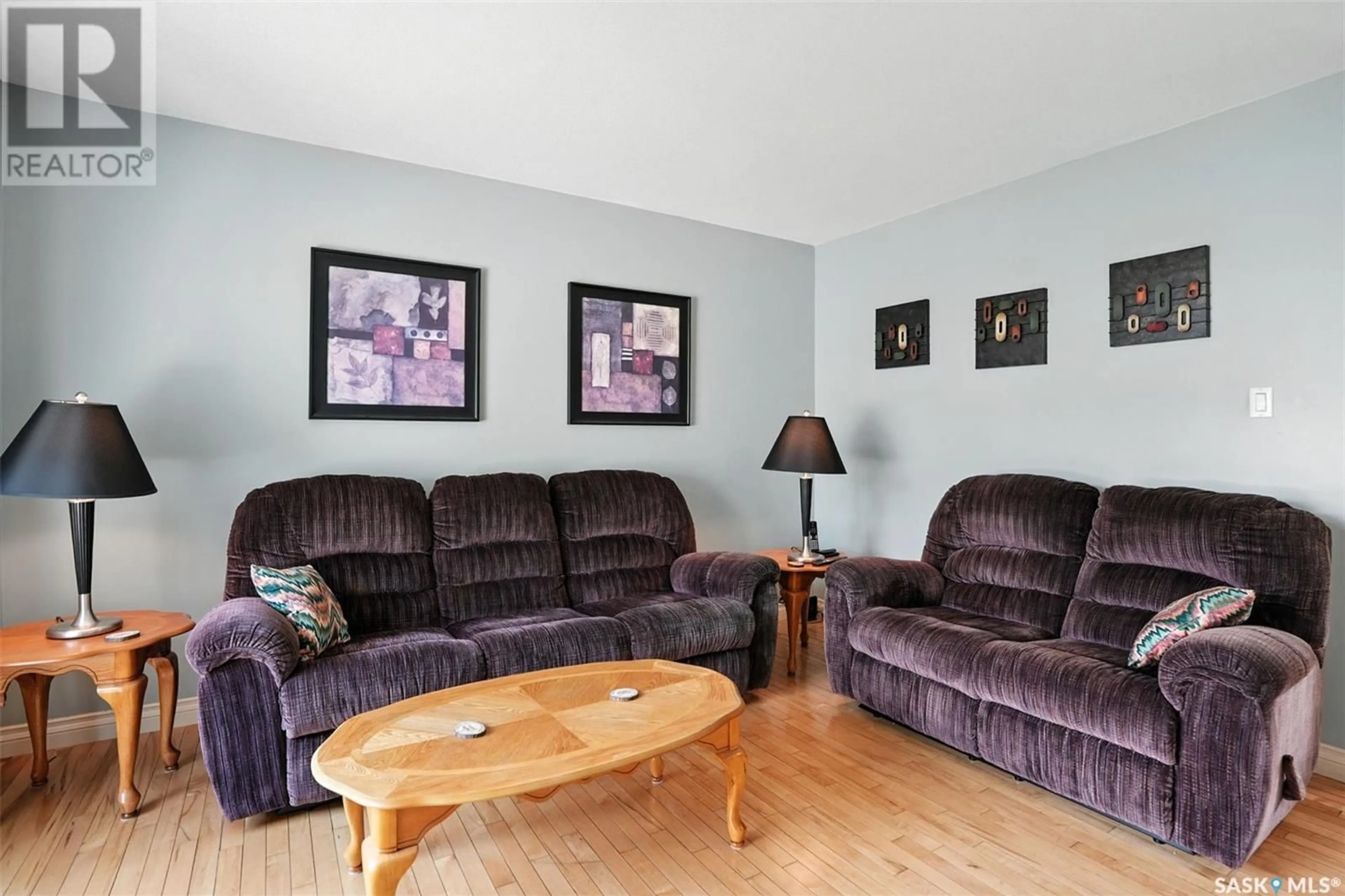 Living room with furniture, wood/laminate floor for 214 LAKERIDGE DRIVE, Warman Saskatchewan S0K0A1