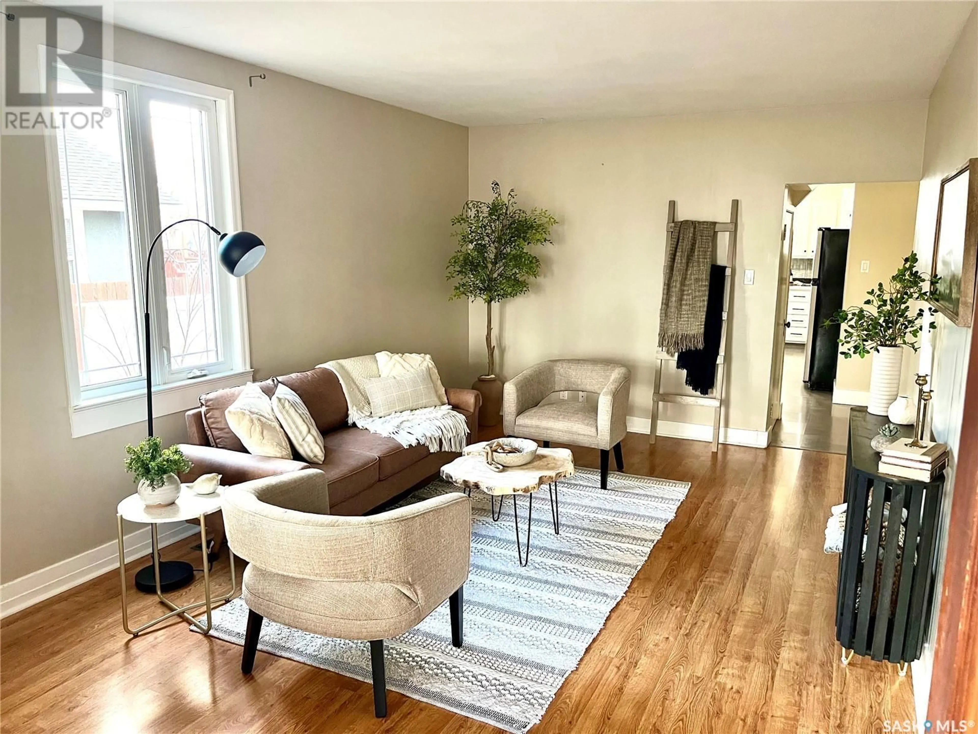 Living room with furniture, wood/laminate floor for 234 5TH AVENUE, Swift Current Saskatchewan S9H3N1