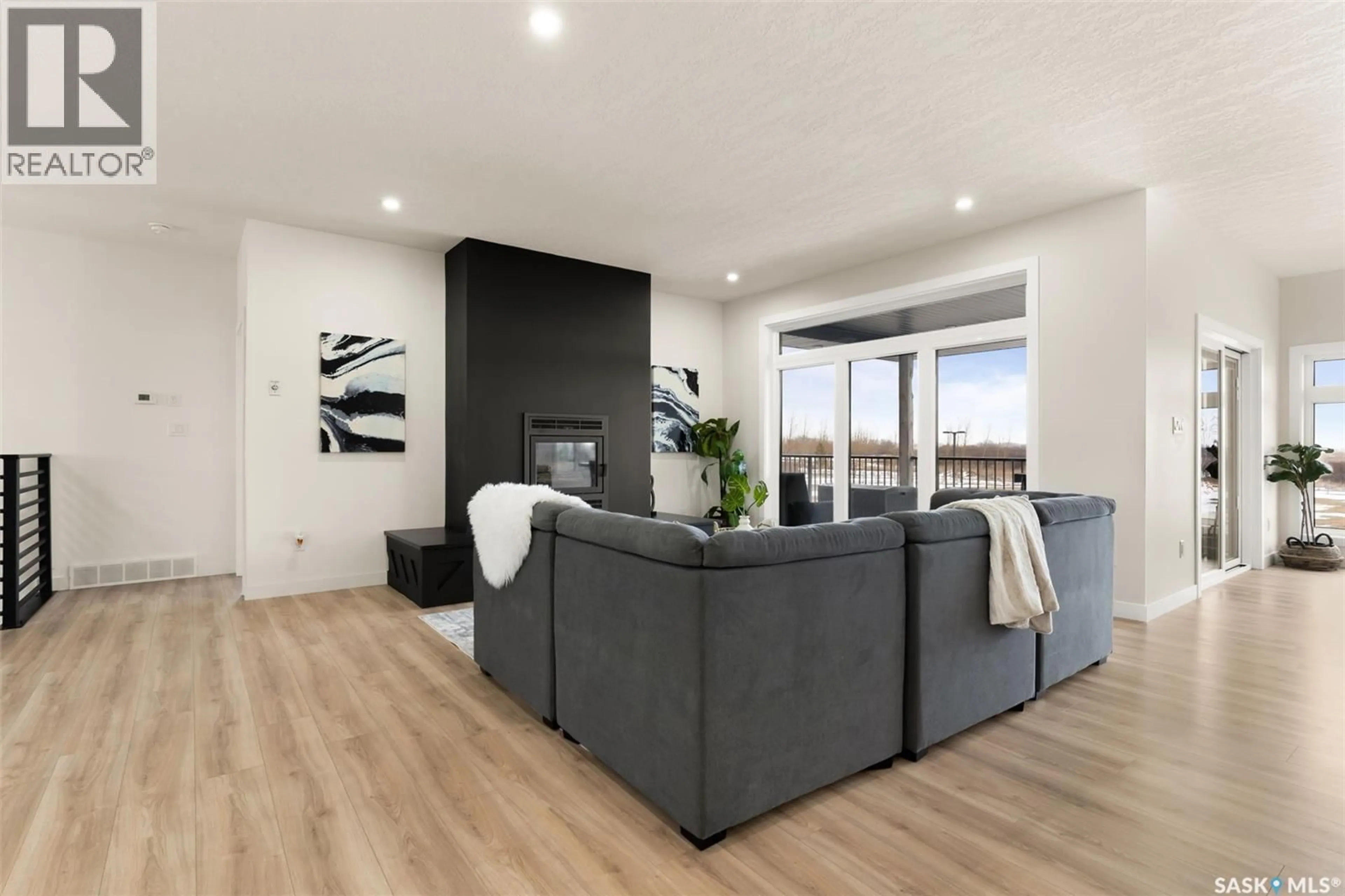Living room with furniture, wood/laminate floor for Hill Acreage BOHACH BAY, Edenwold Rm No.158 Saskatchewan S4L5B1