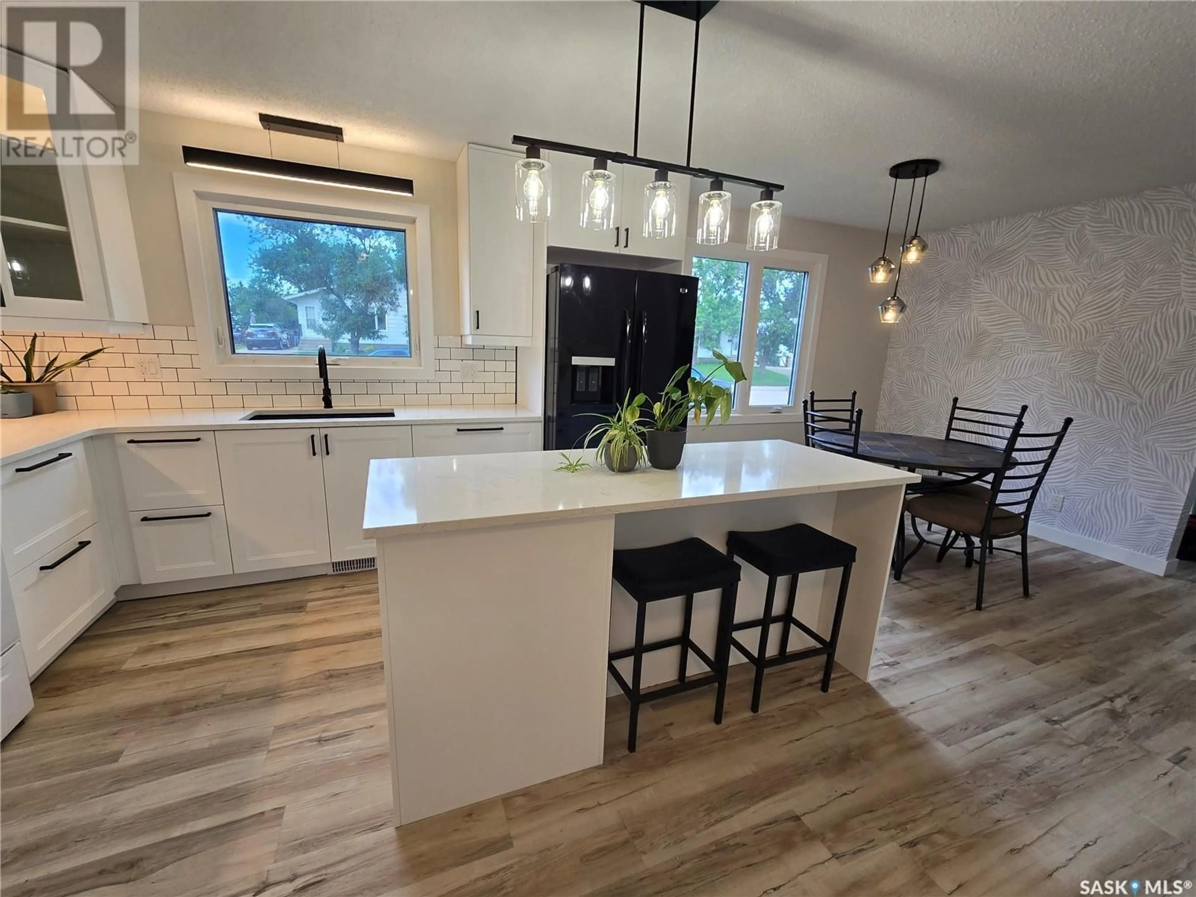 Open concept kitchen, wood/laminate floor for 214 PELLETIER DRIVE, Swift Current Saskatchewan S9H4K4
