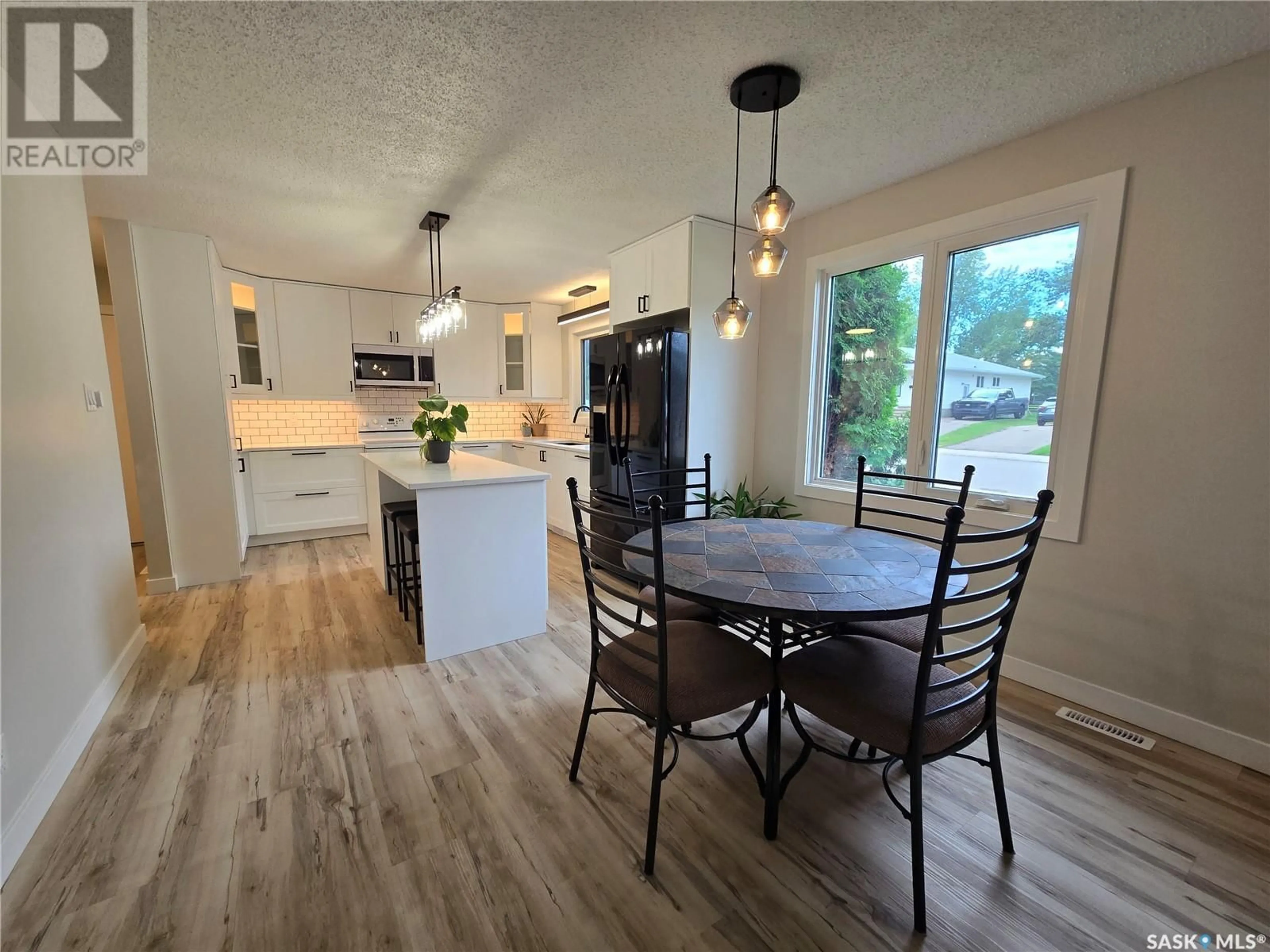 Open concept kitchen, wood/laminate floor for 214 PELLETIER DRIVE, Swift Current Saskatchewan S9H4K4