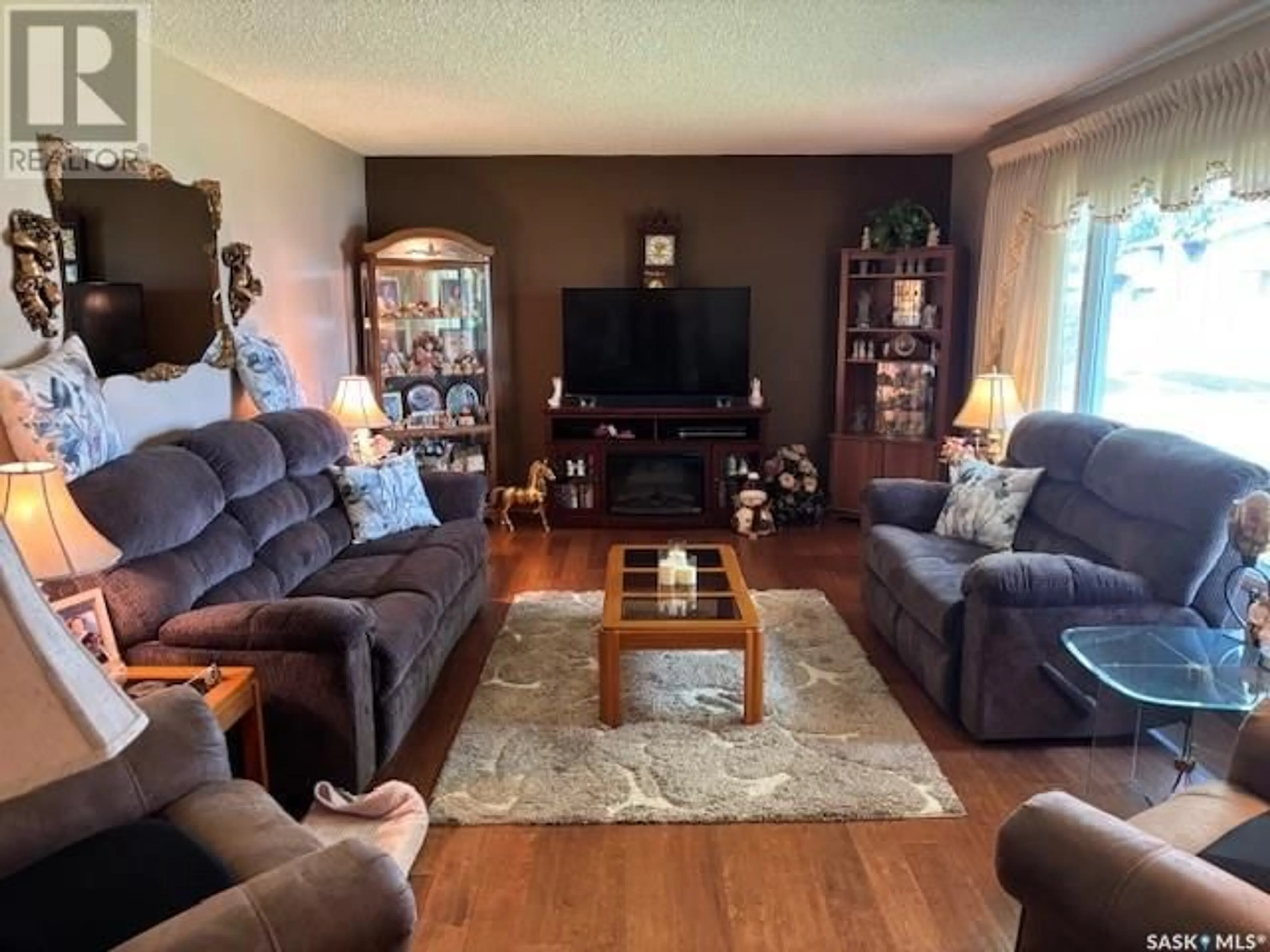 Living room with furniture, wood/laminate floor for 204 SHEVCHENKO CRESCENT, Canora Saskatchewan S0A0L0