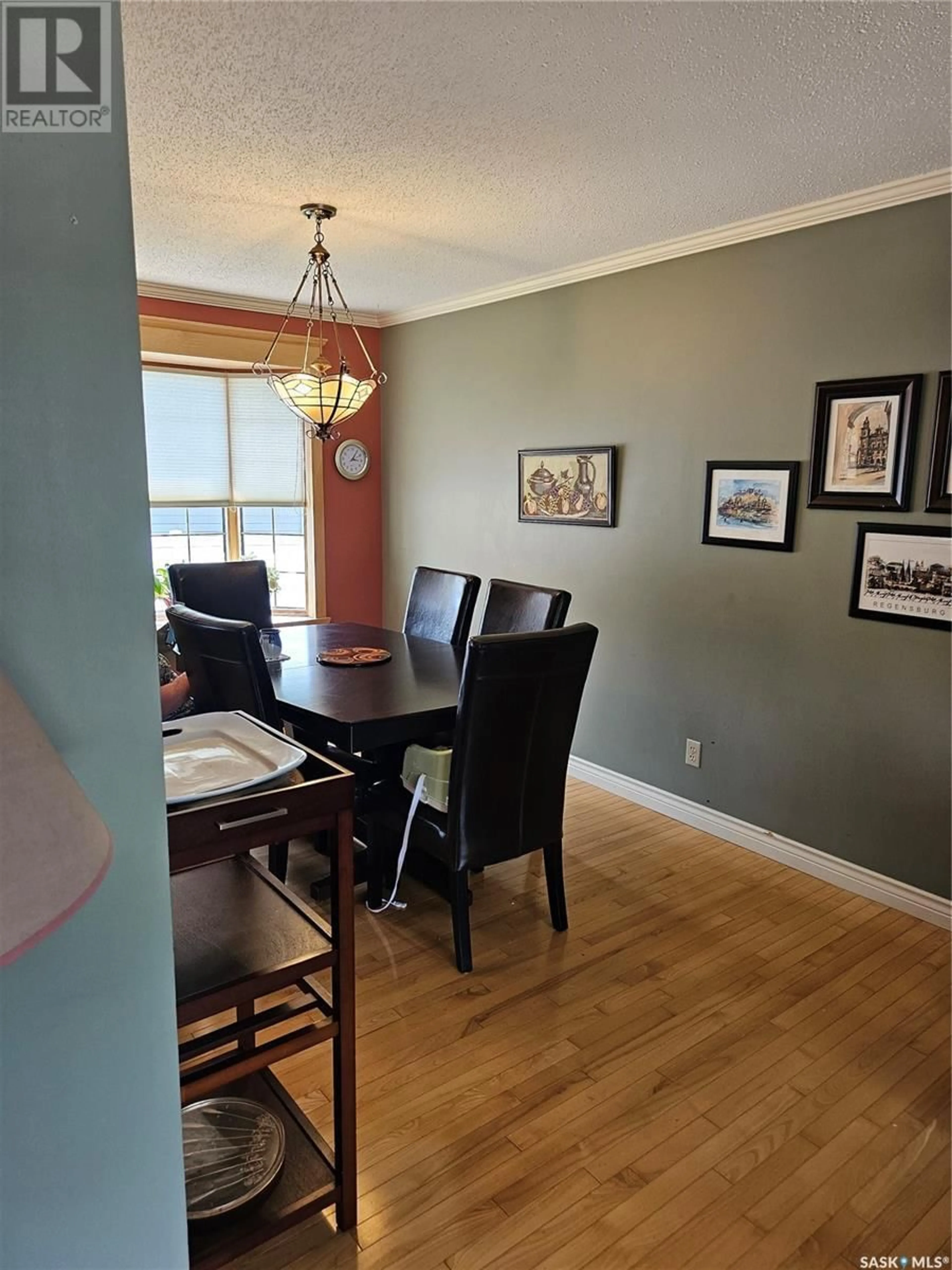 Dining room, wood/laminate floor for 702 MCKERCHER DRIVE, Saskatoon Saskatchewan S7H3W7