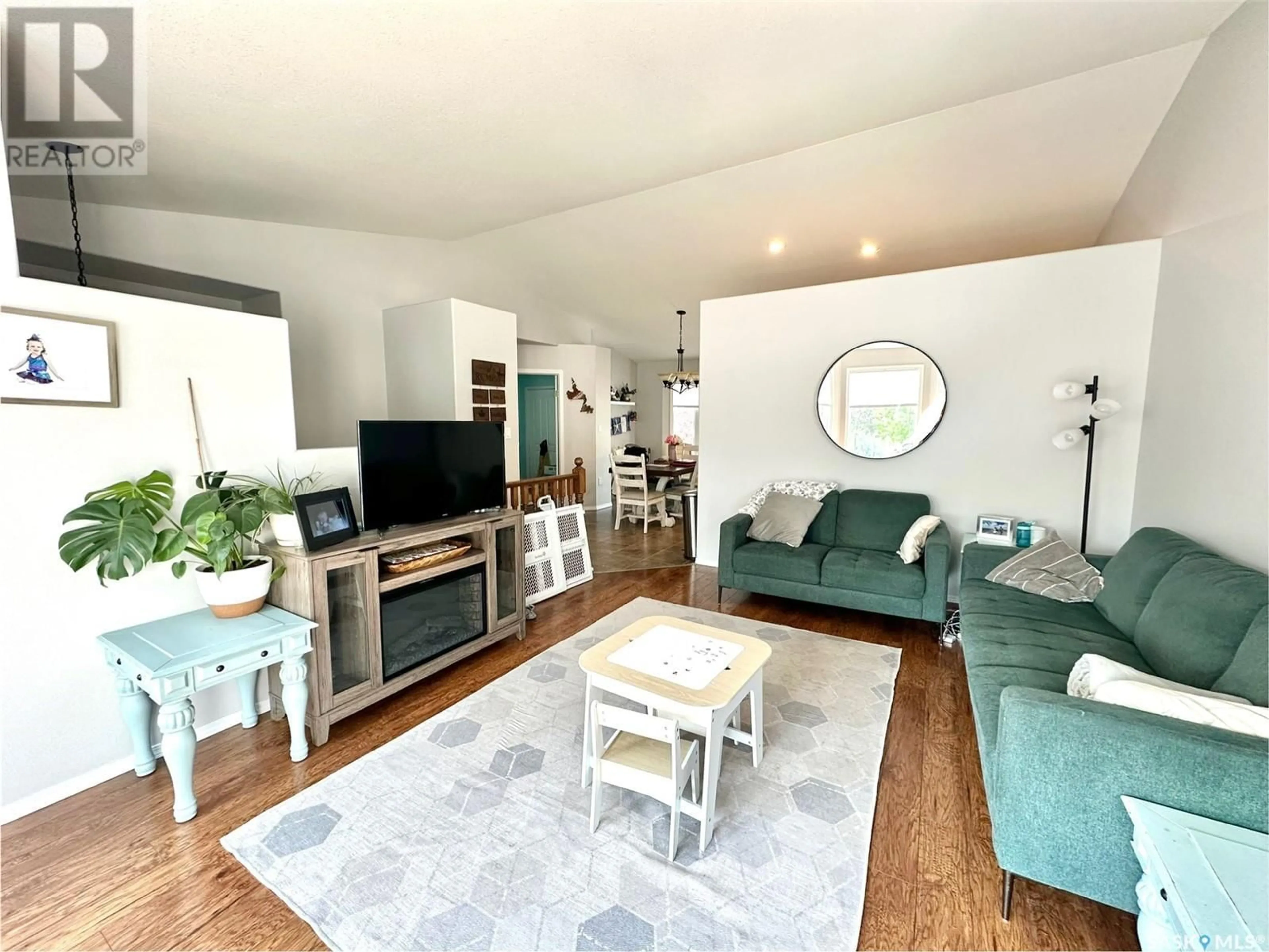 Living room with furniture, wood/laminate floor for 10317 HENDERSON DRIVE, North Battleford Saskatchewan S9A3Y9