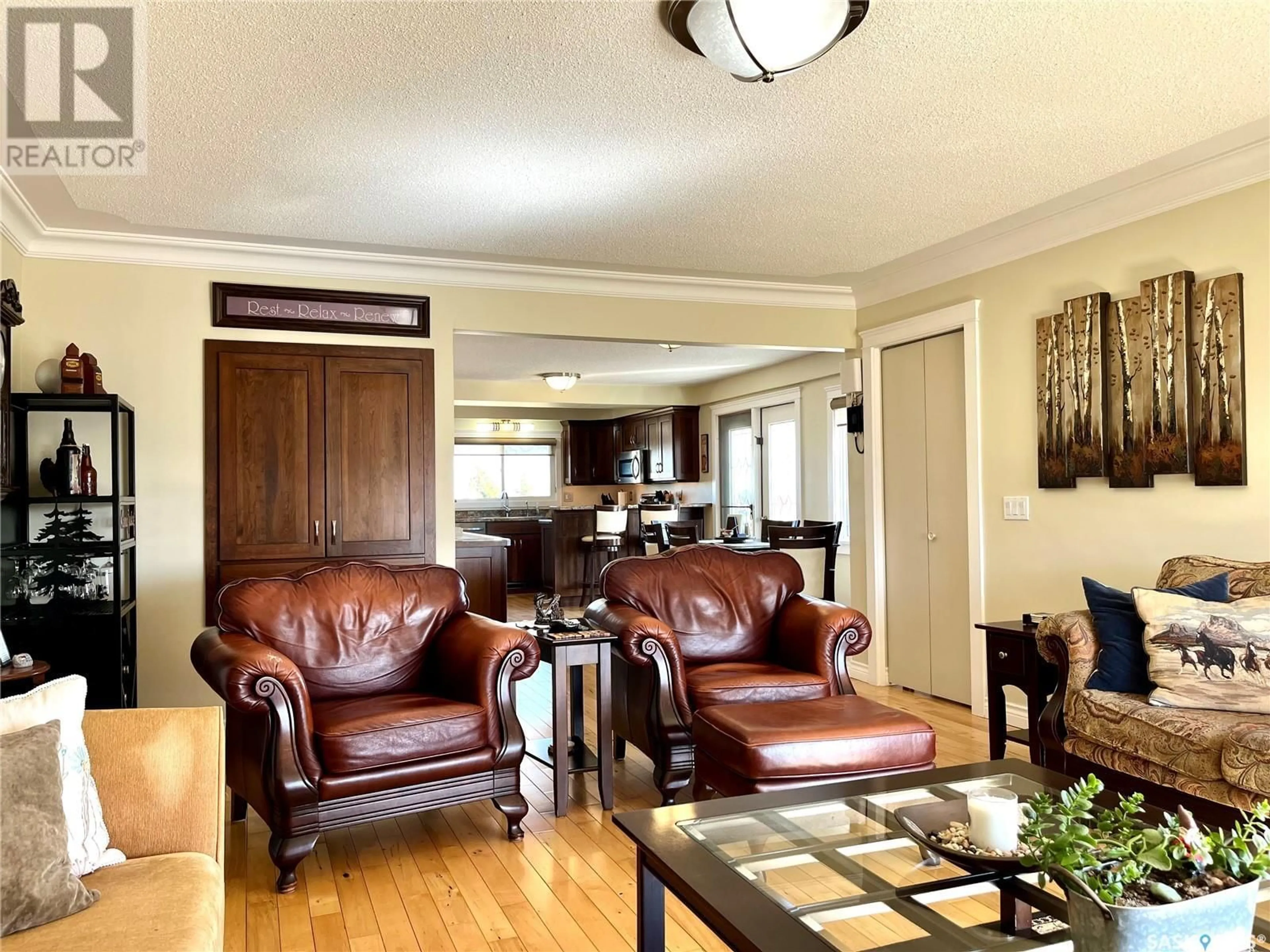 Living room with furniture, wood/laminate floor for CADRAIN ACRES, Swift Current Rm No. 137 Saskatchewan S9H5K8