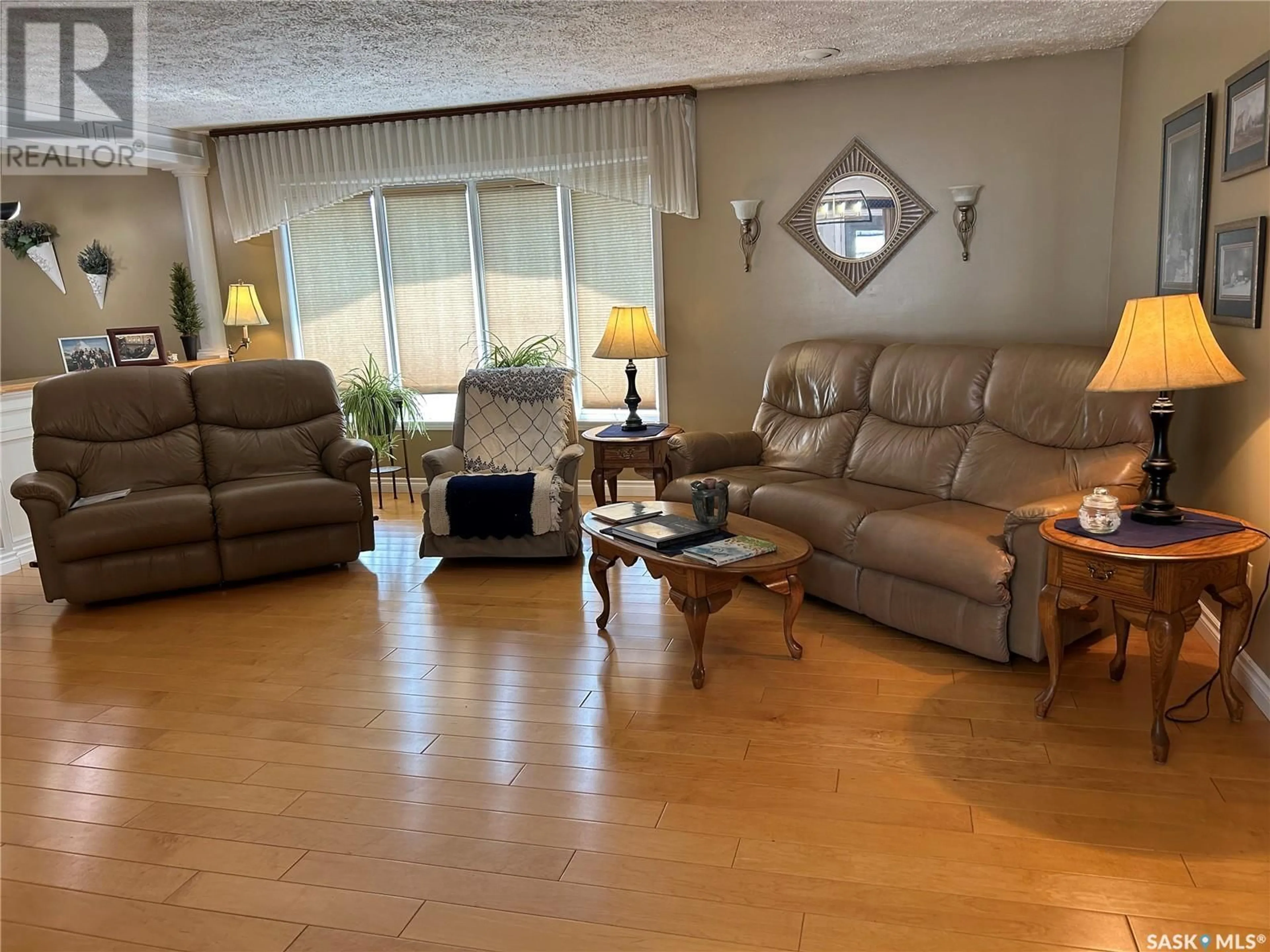 Living room with furniture, wood/laminate floor for 1294 VETERANS CRESCENT, Estevan Saskatchewan S4A2E1