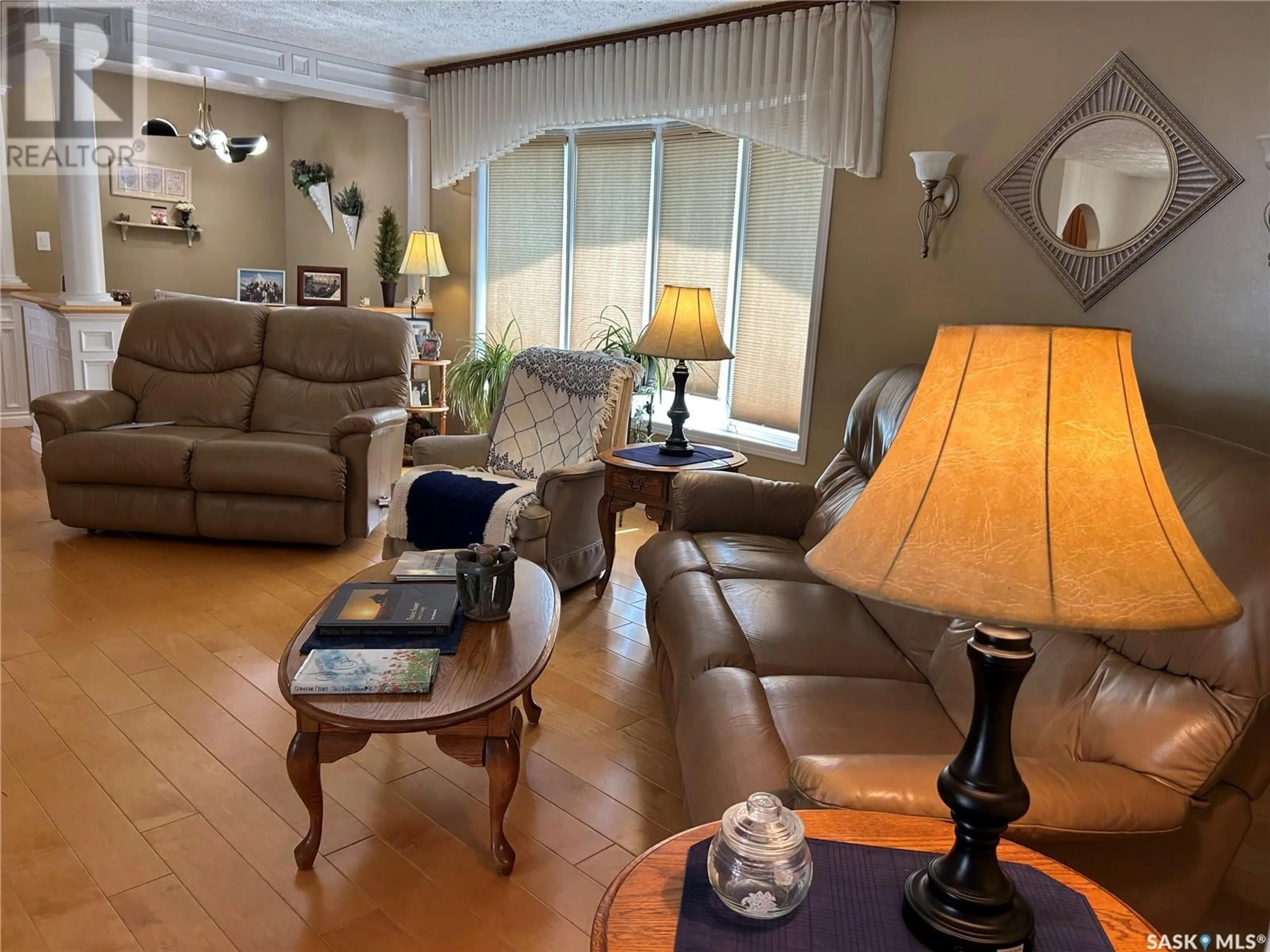 Living room with furniture, wood/laminate floor for 1294 VETERANS CRESCENT, Estevan Saskatchewan S4A2E1