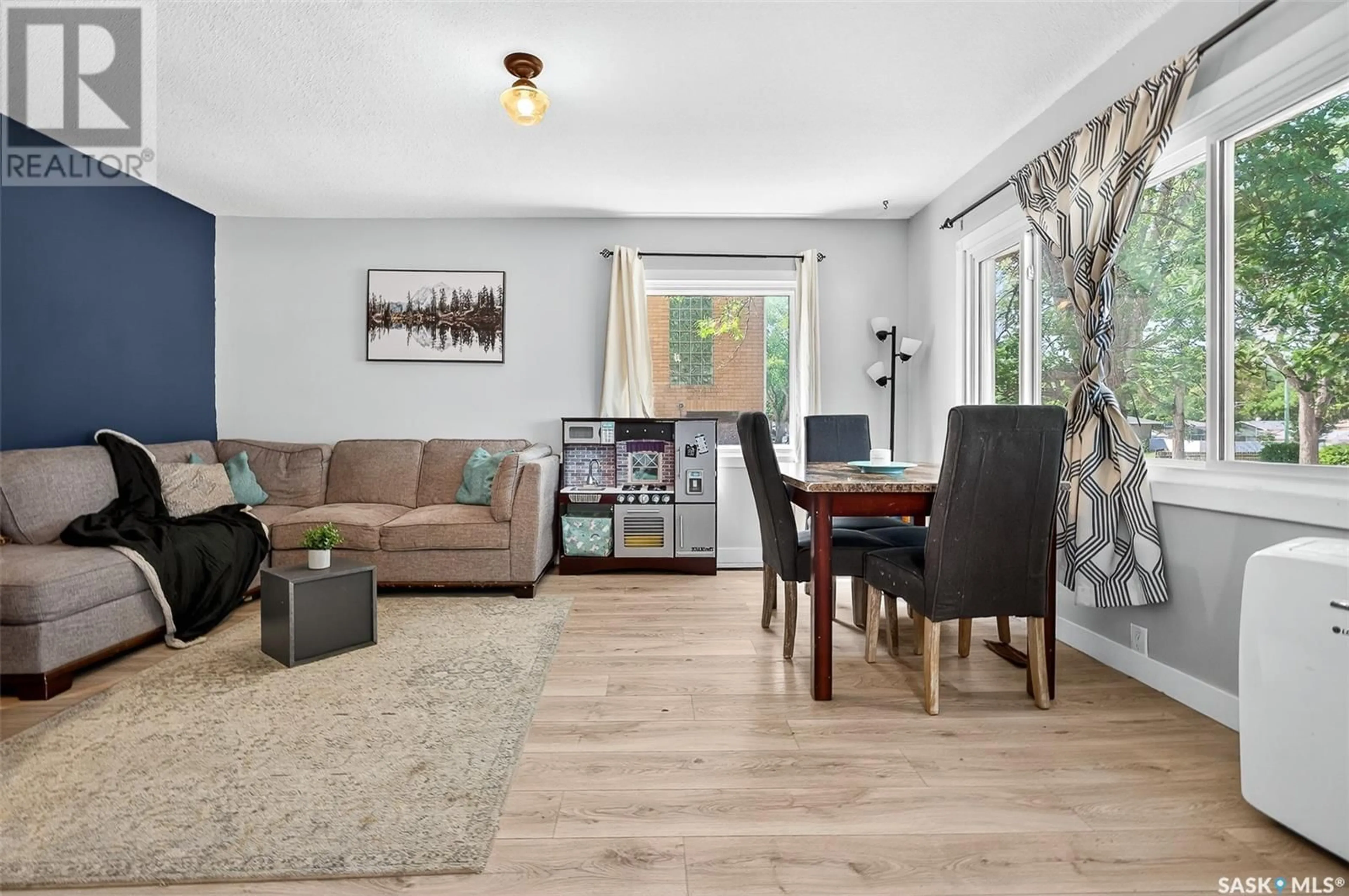 Living room with furniture, wood/laminate floor for 657 GRANDVIEW STREET, Moose Jaw Saskatchewan S6H5L3