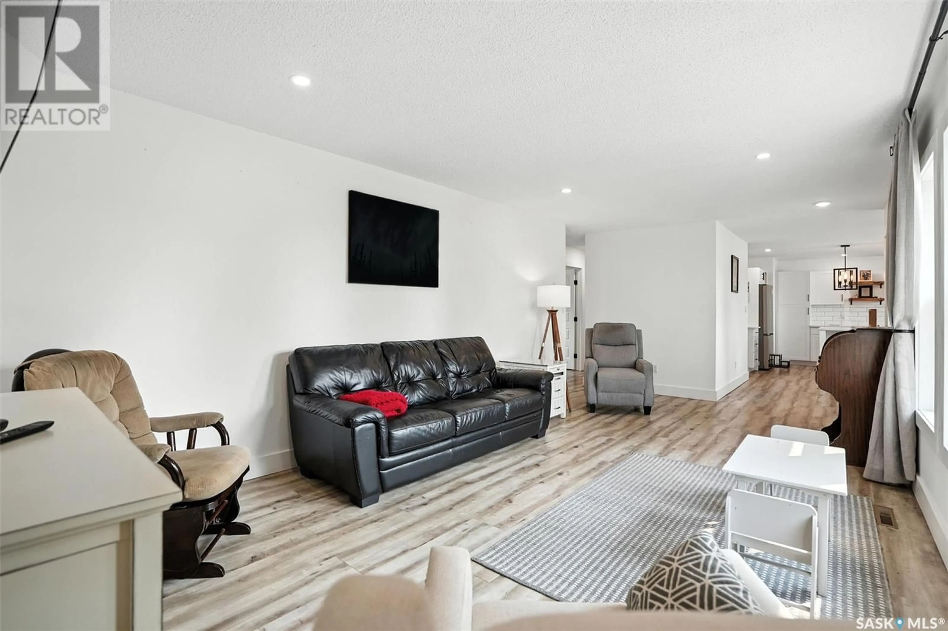 Living room with furniture, wood/laminate floor for 213 3RD AVENUE, Rosthern Saskatchewan S0K3R0