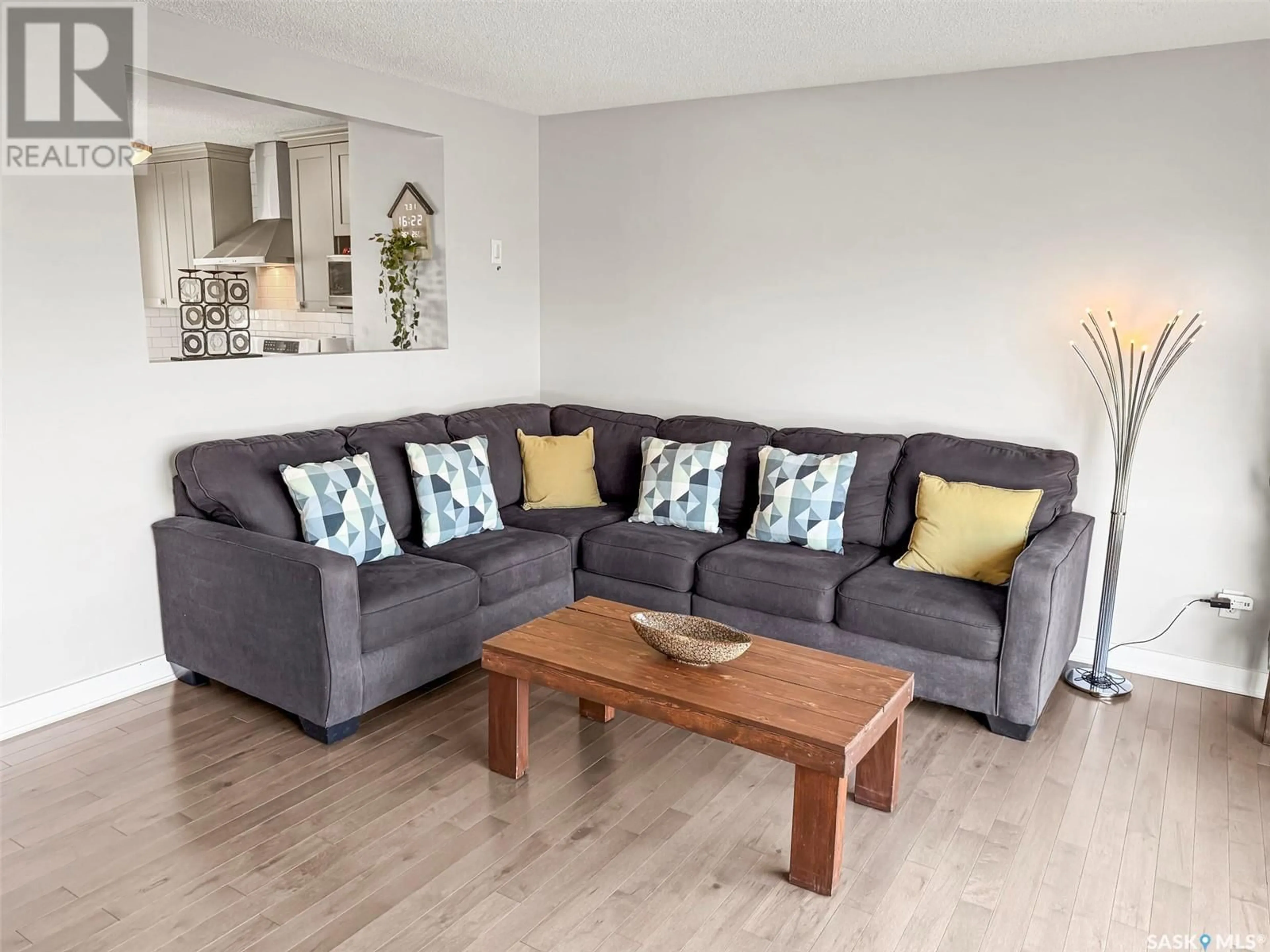 Living room with furniture, wood/laminate floor for 212 CLINTON PLACE, Swift Current Saskatchewan S9H4K2