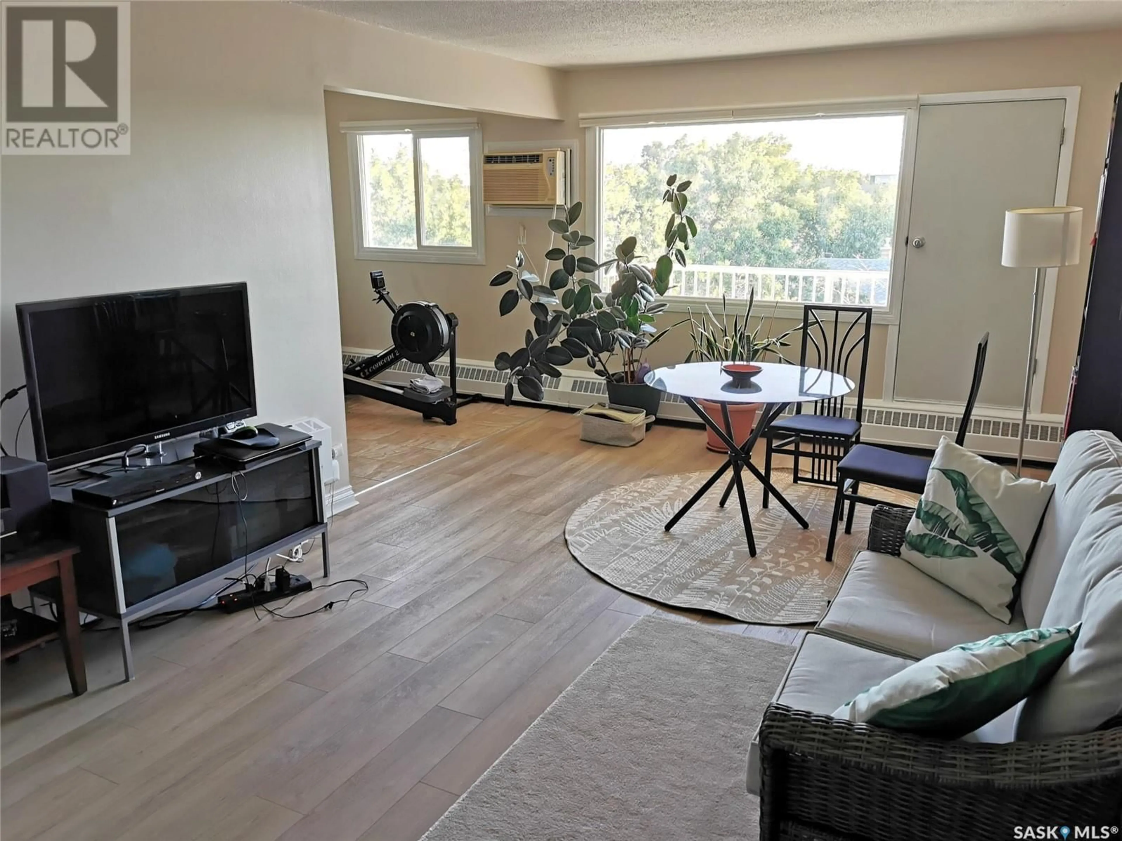 Living room with furniture, wood/laminate floor for 18 - 1811 8TH AVENUE N, Regina Saskatchewan S4R0G5