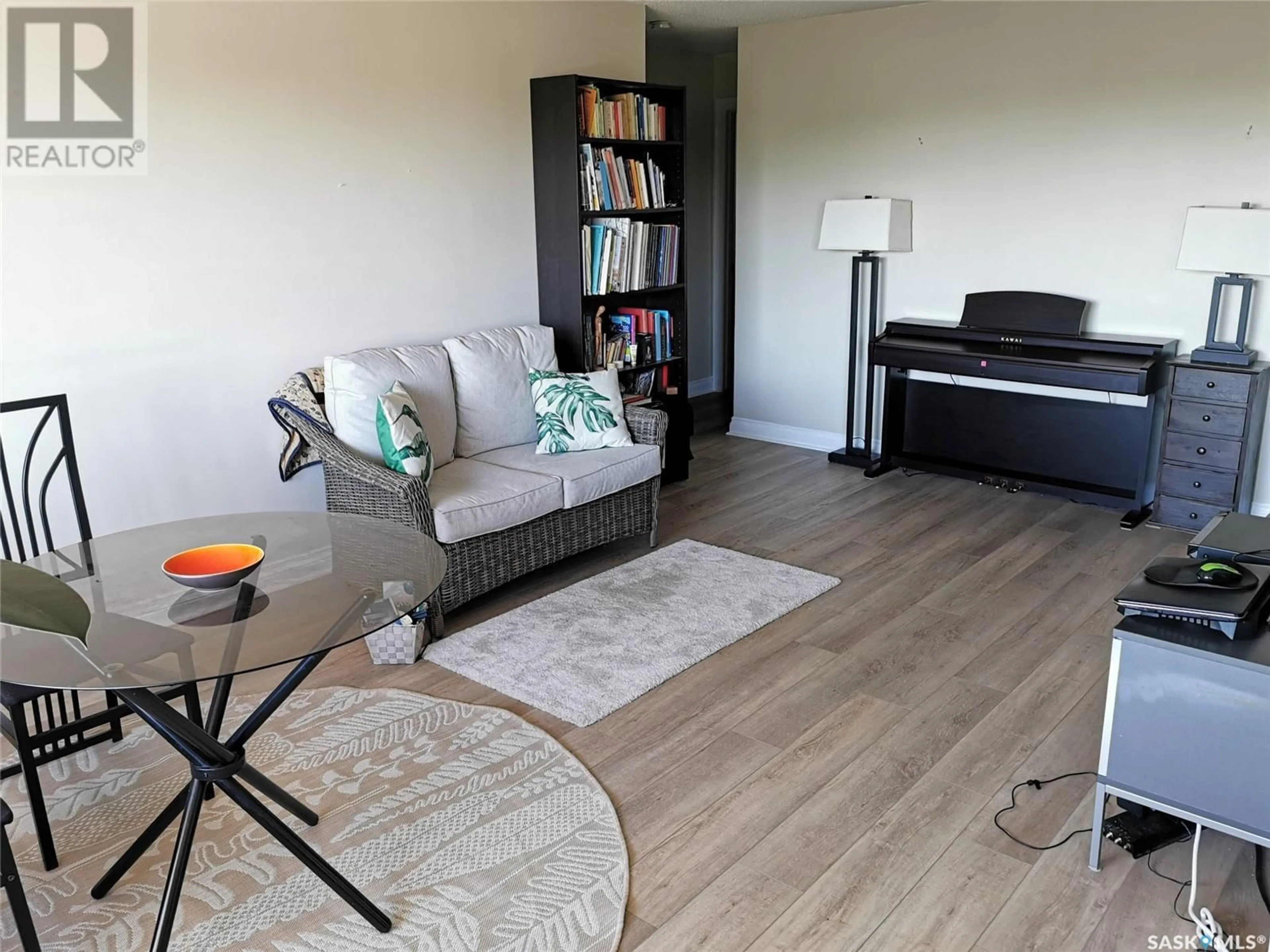 Living room with furniture, wood/laminate floor for 18 - 1811 8TH AVENUE N, Regina Saskatchewan S4R0G5