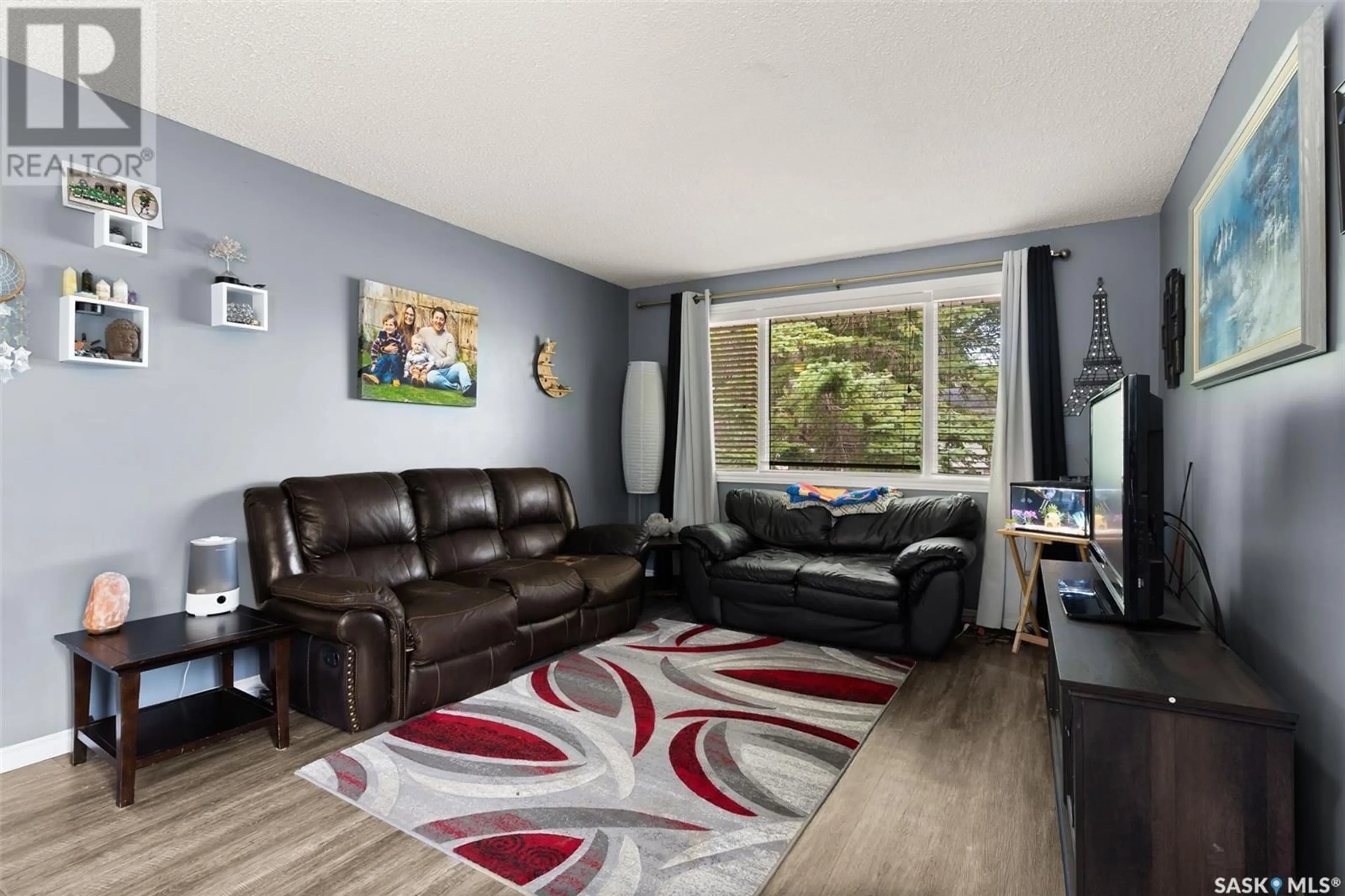 Living room with furniture, wood/laminate floor for 49 MITCHELL CRESCENT, Regina Saskatchewan S4R5G5