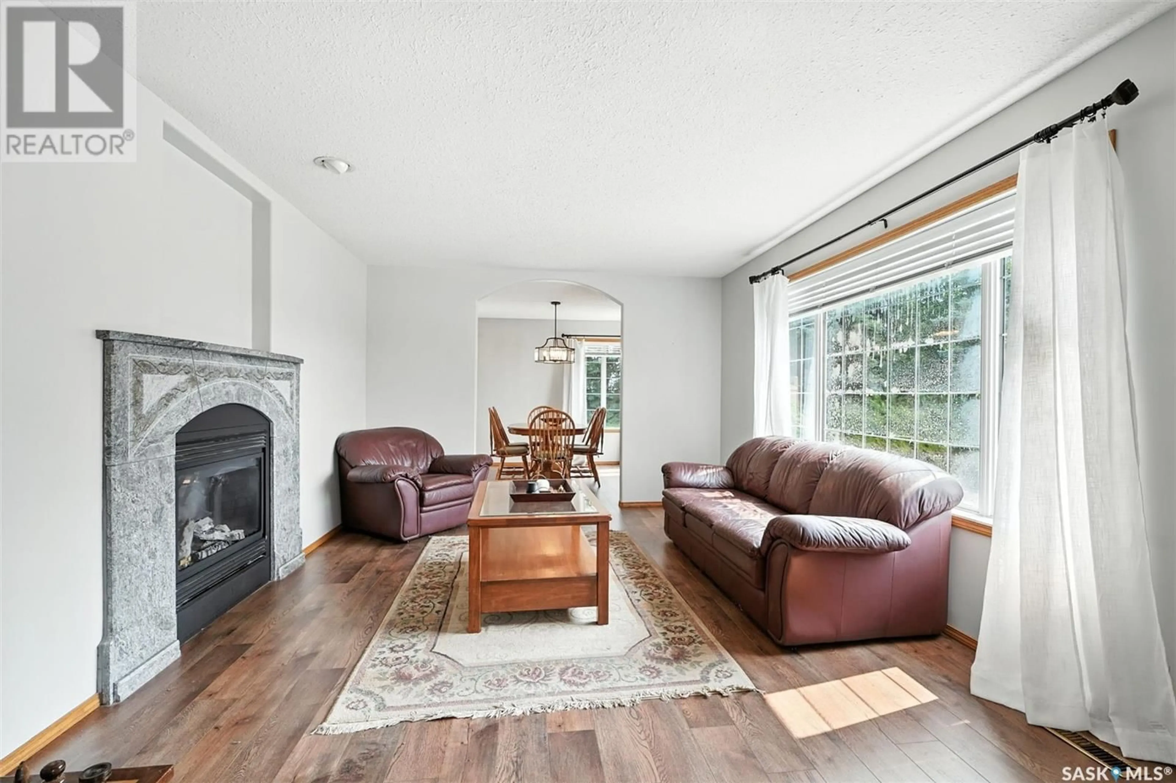 Living room with furniture, wood/laminate floor for ASSIE ACREAGE, Blucher Rm No. 343 Saskatchewan S0K0Y0