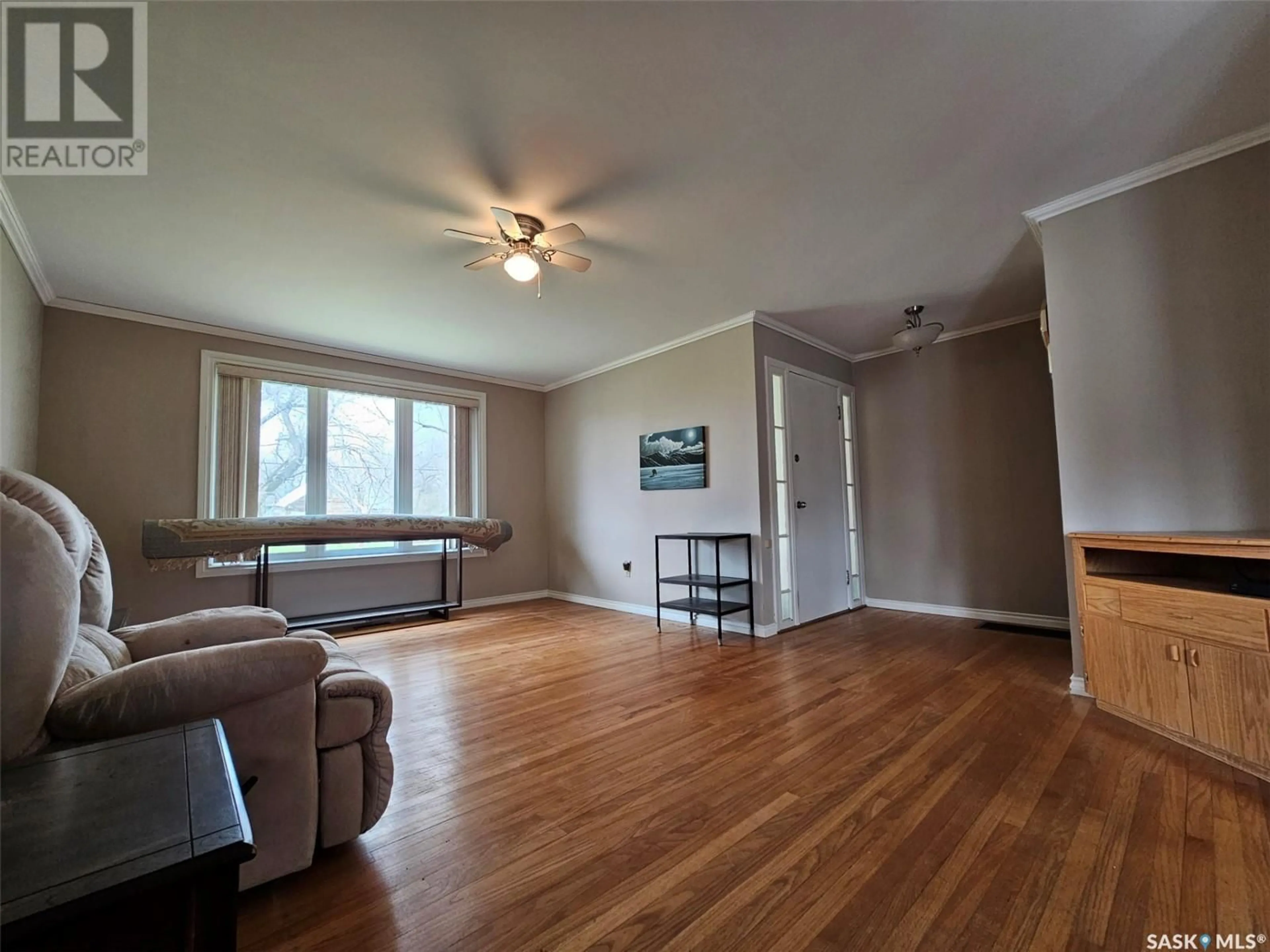 Living room with furniture, wood/laminate floor for 245 1ST AVENUE, Mankota Saskatchewan S0H2W0