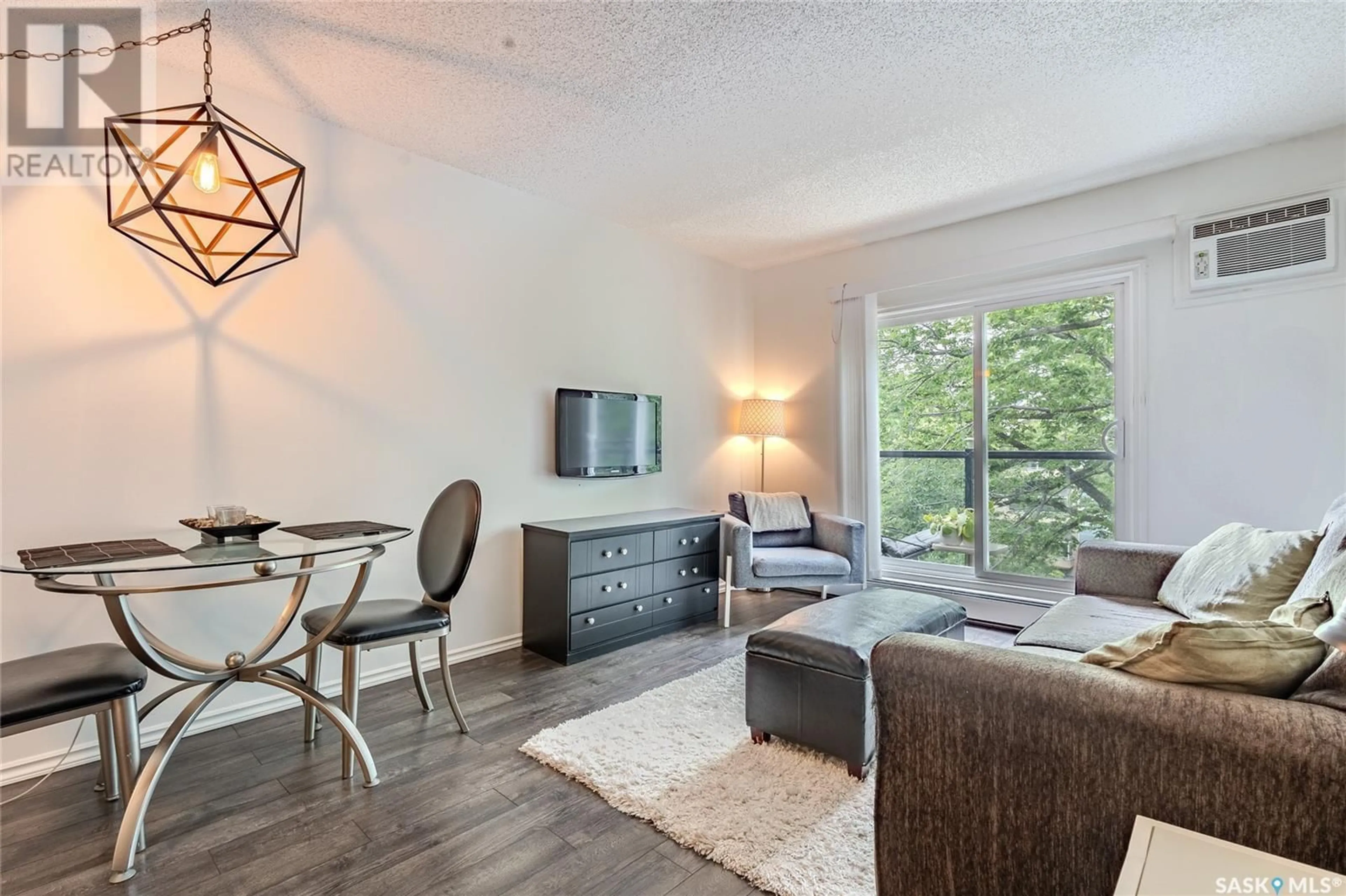 Living room with furniture, wood/laminate floor for 30 1001 LANDSDOWNE AVENUE, Saskatoon Saskatchewan S7H2C2