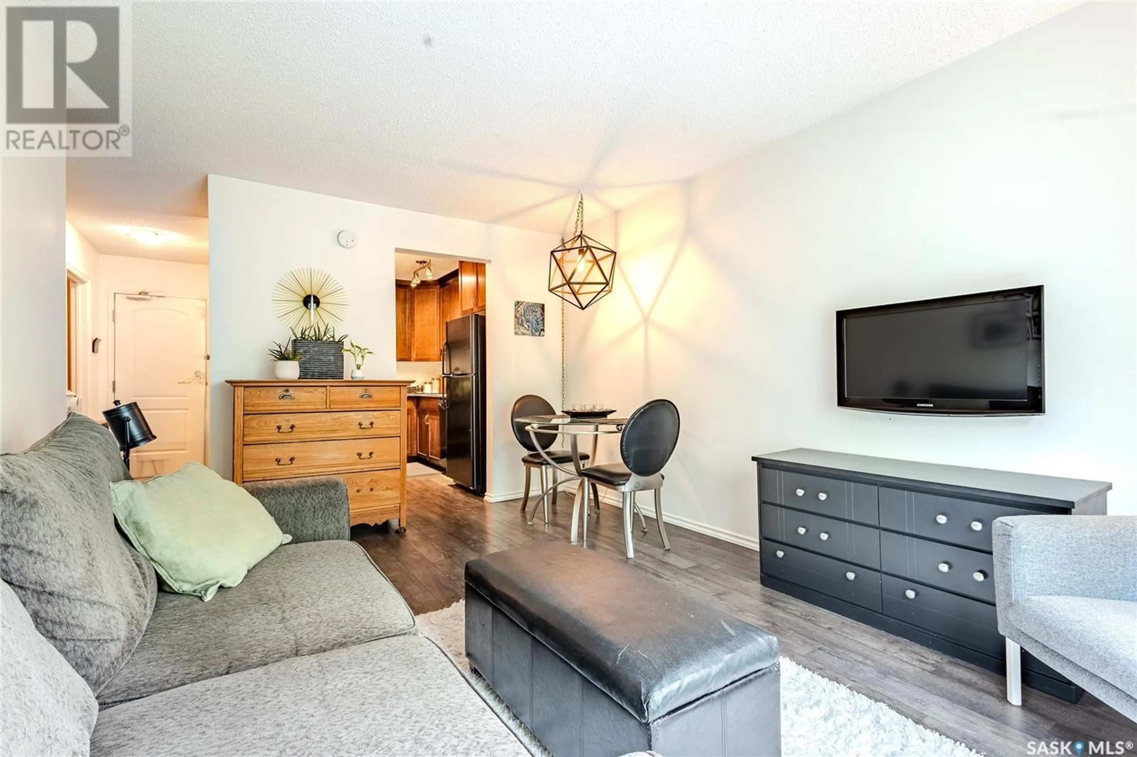 Living room with furniture, wood/laminate floor for 30 1001 LANDSDOWNE AVENUE, Saskatoon Saskatchewan S7H2C2
