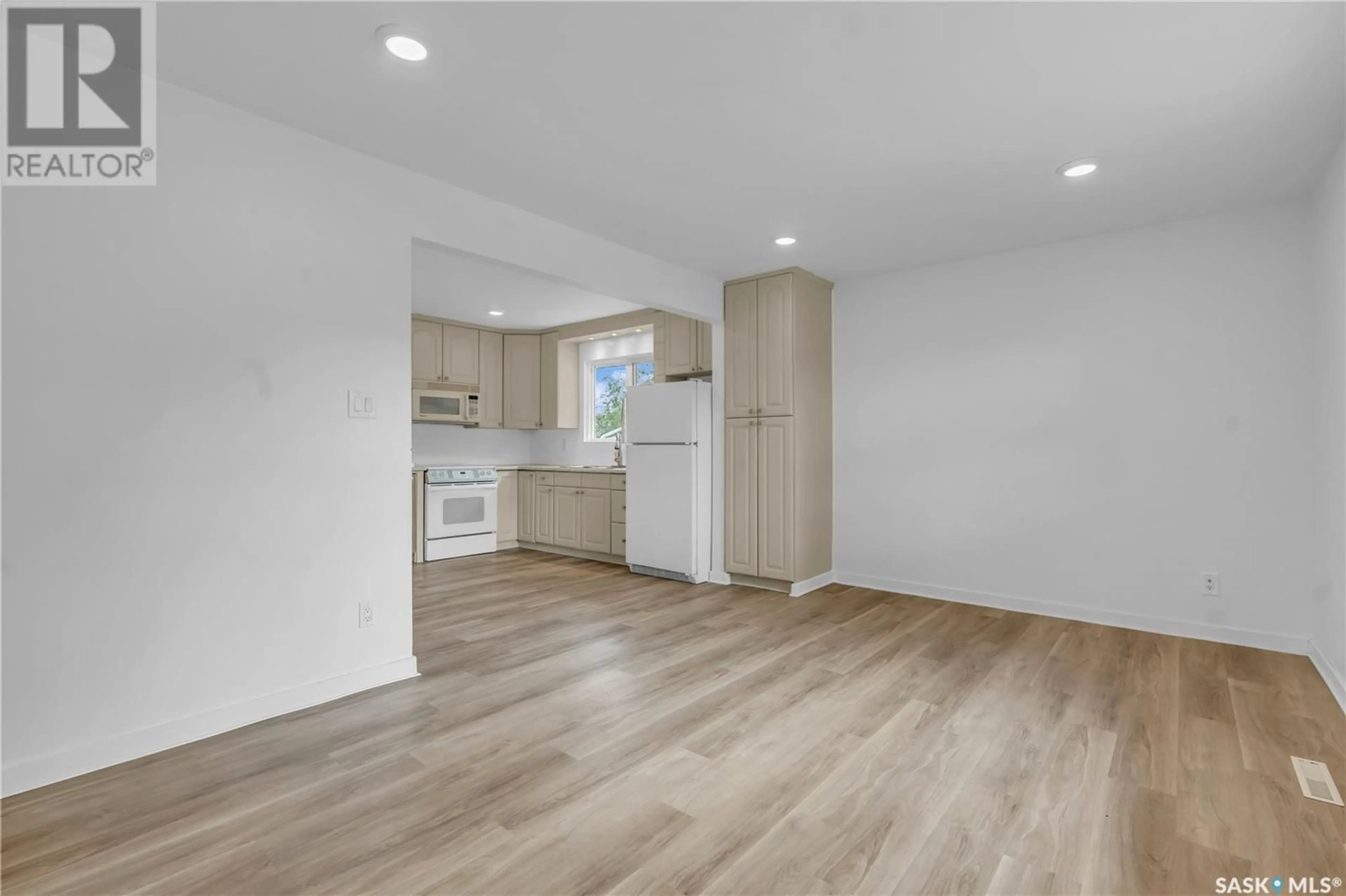 Open concept kitchen, wood/laminate floor for 934 TROTTER CRESCENT, Saskatoon Saskatchewan S7L3R1