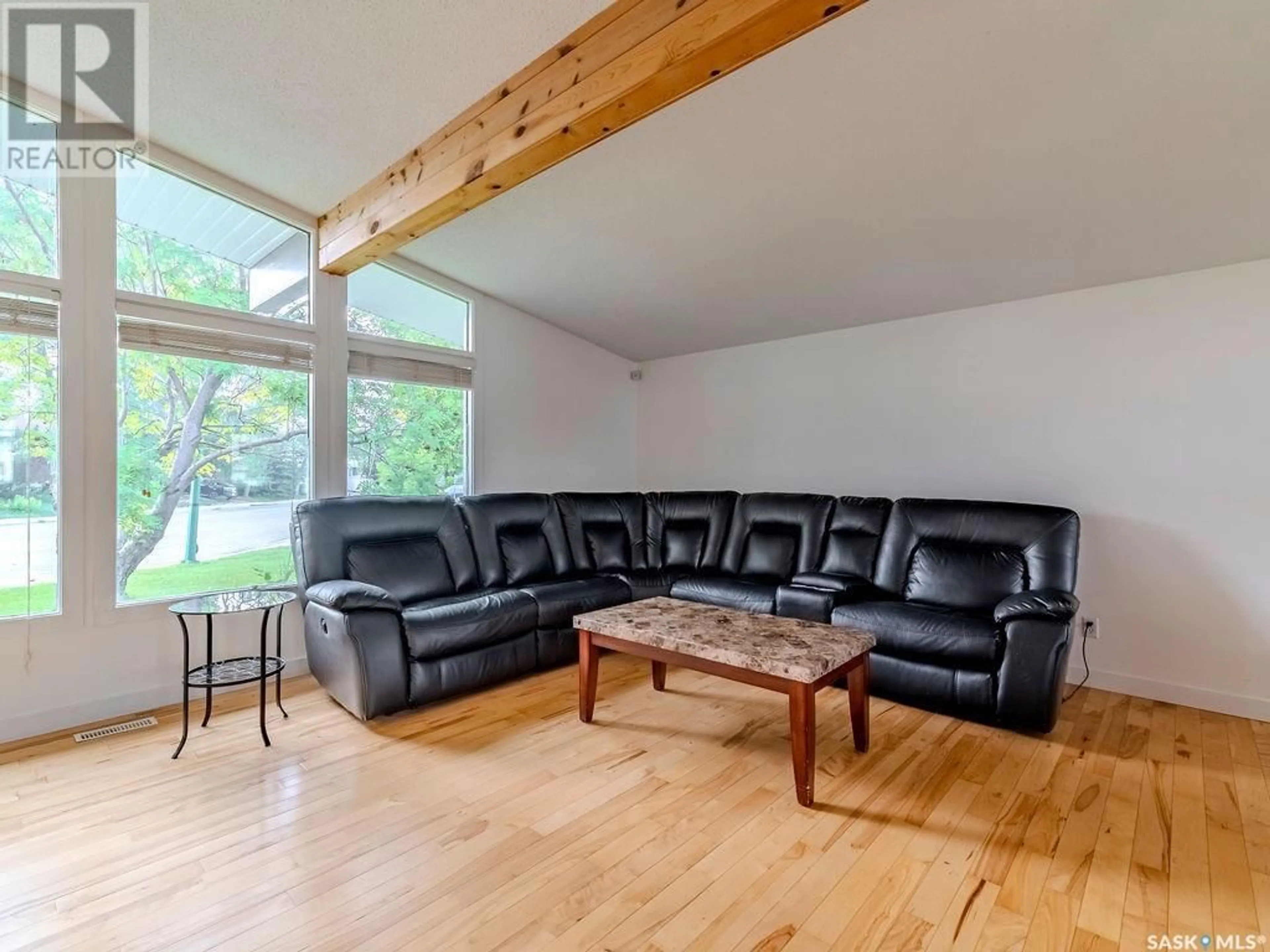 Living room with furniture, wood/laminate floor for 246 ANDERSON CRESCENT, Saskatoon Saskatchewan S7H4C2