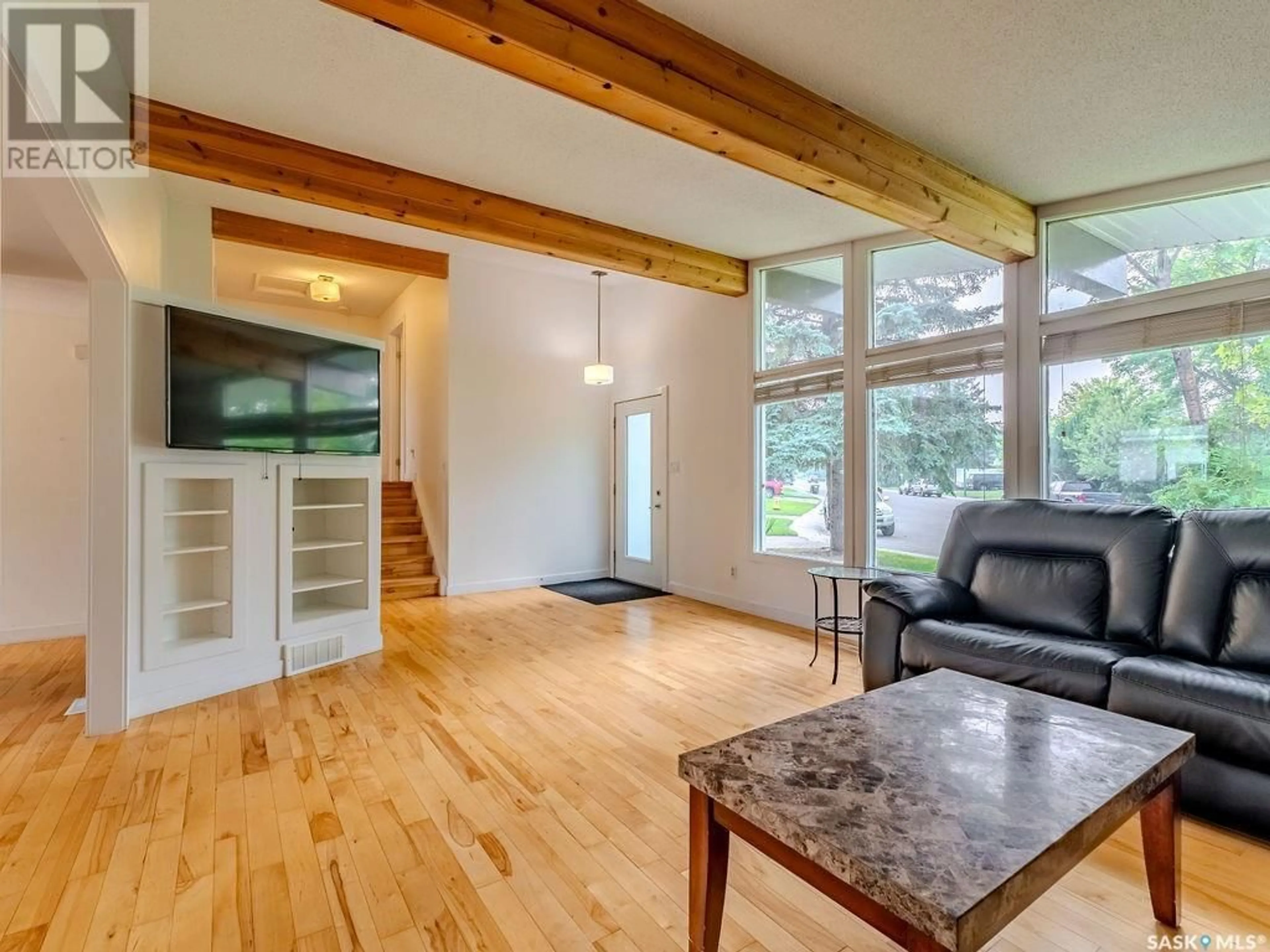 Living room with furniture, wood/laminate floor for 246 ANDERSON CRESCENT, Saskatoon Saskatchewan S7H4C2