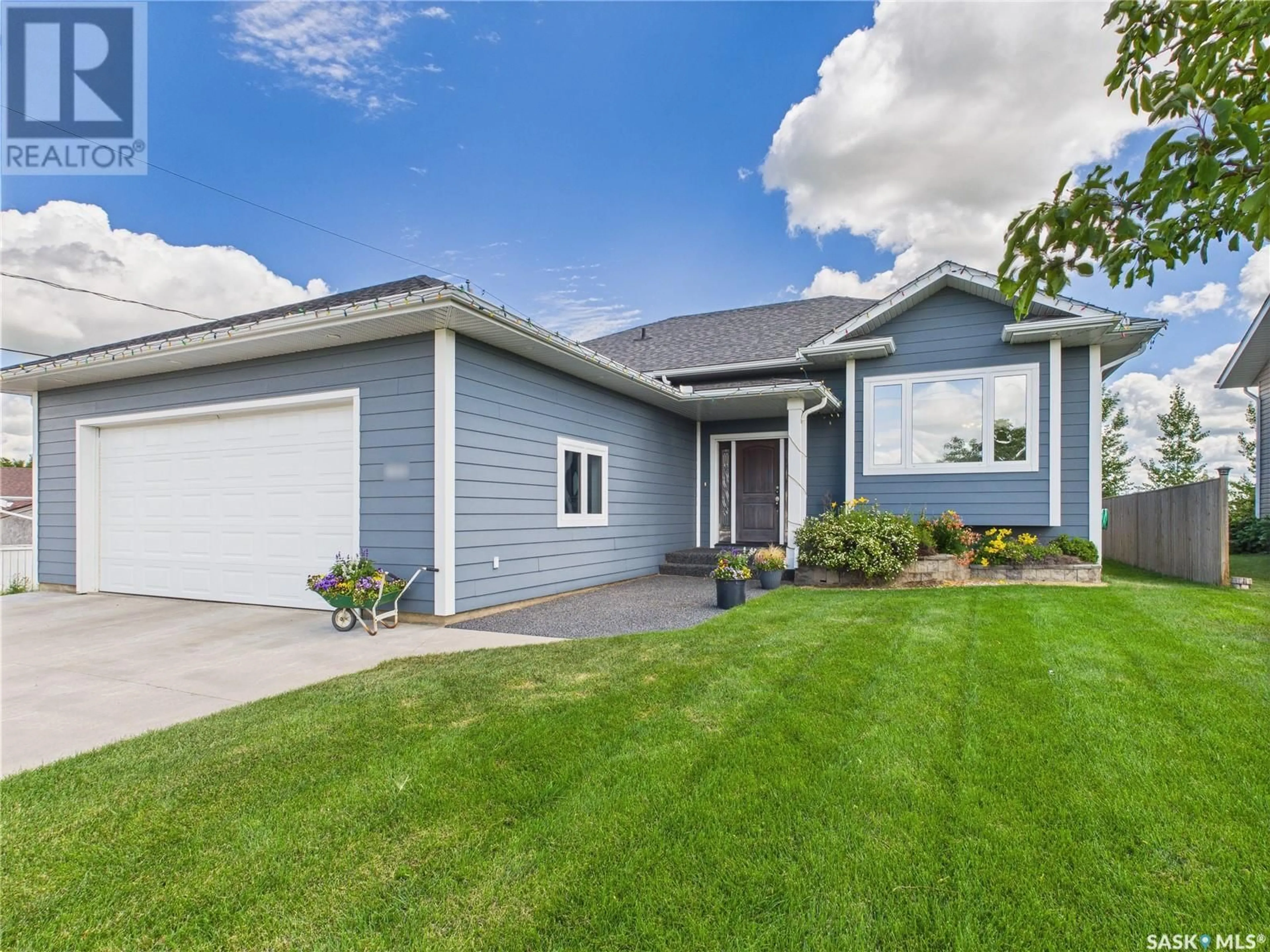 Home with vinyl exterior material, street for 100 E 2ND STREET, Birch Hills Saskatchewan S0J0G0