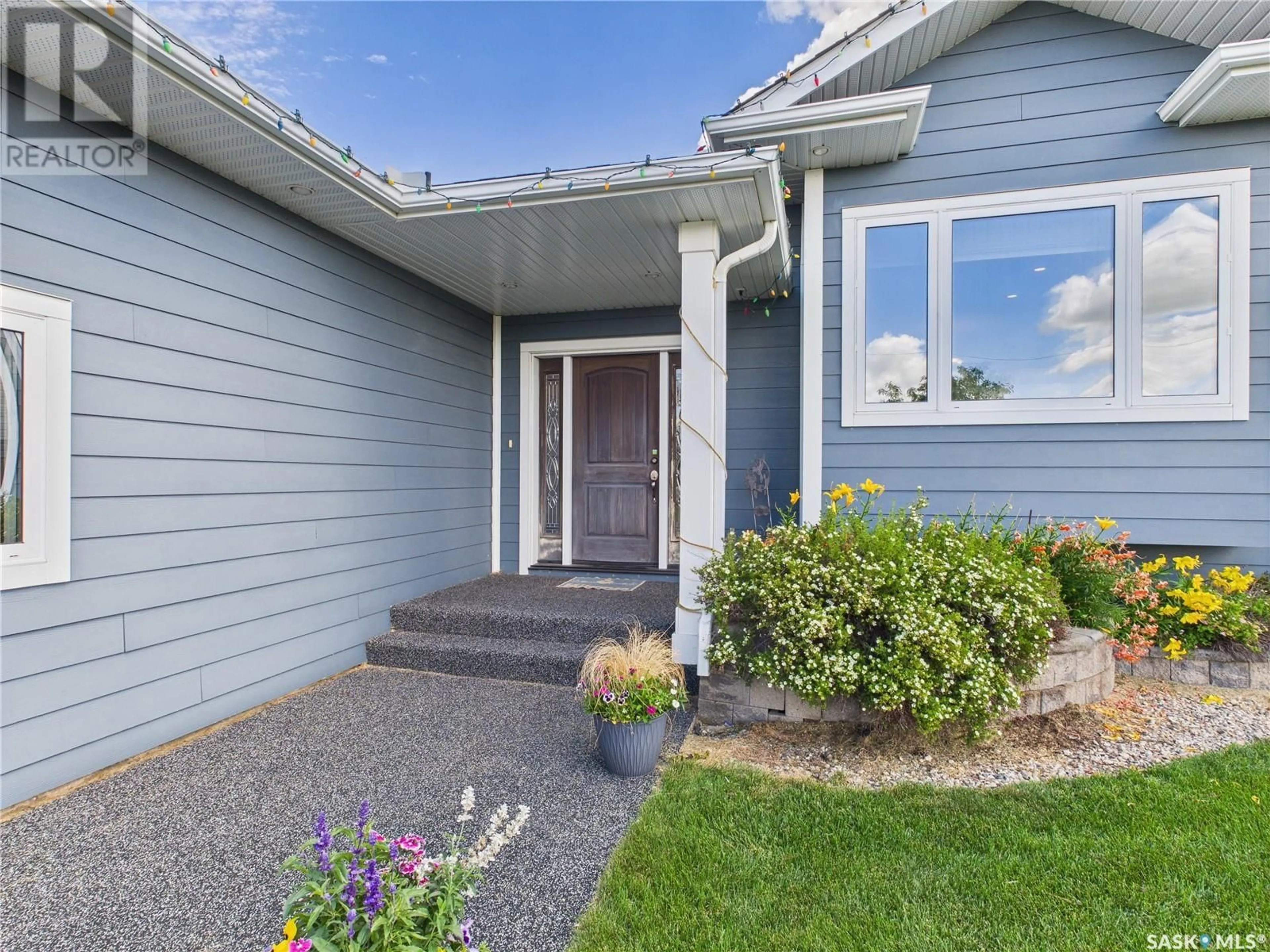 Home with vinyl exterior material, street for 100 E 2ND STREET, Birch Hills Saskatchewan S0J0G0