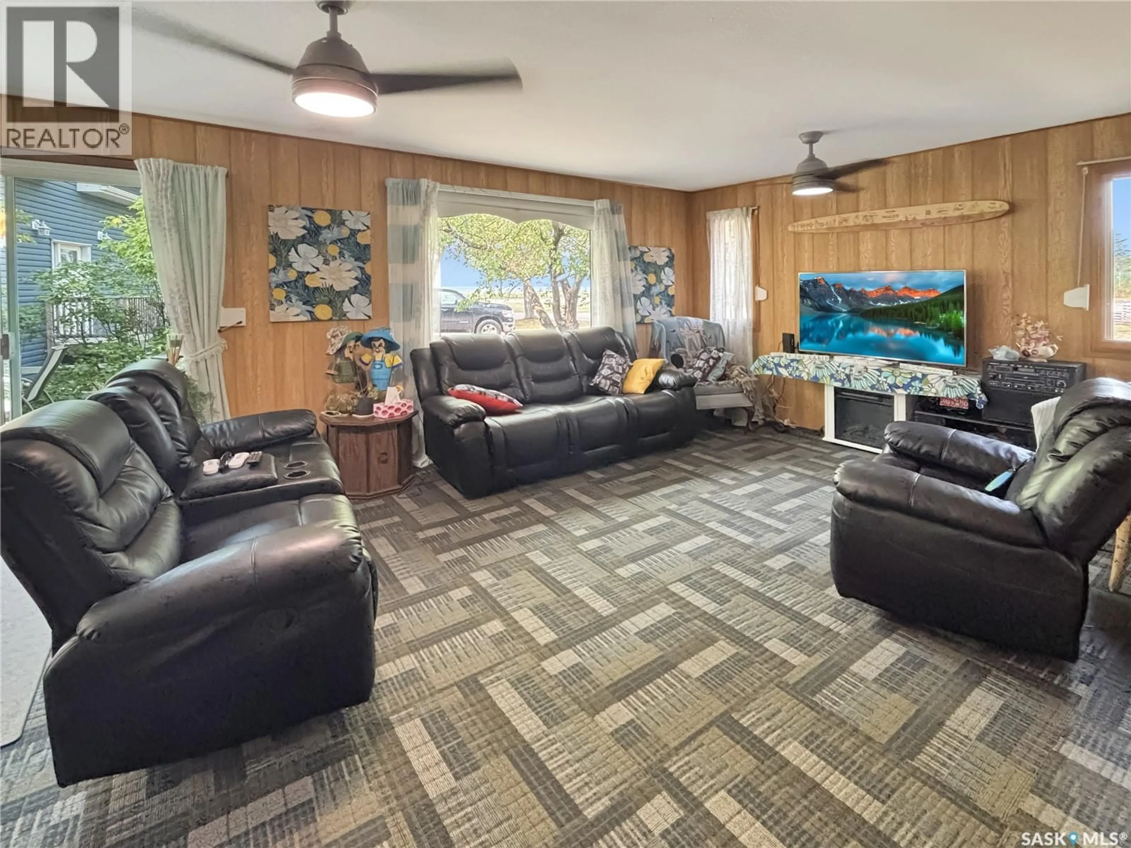 Living room with furniture, wood/laminate floor for 9261 CLEMENT CRESCENT, Cochin Saskatchewan S0M0L0