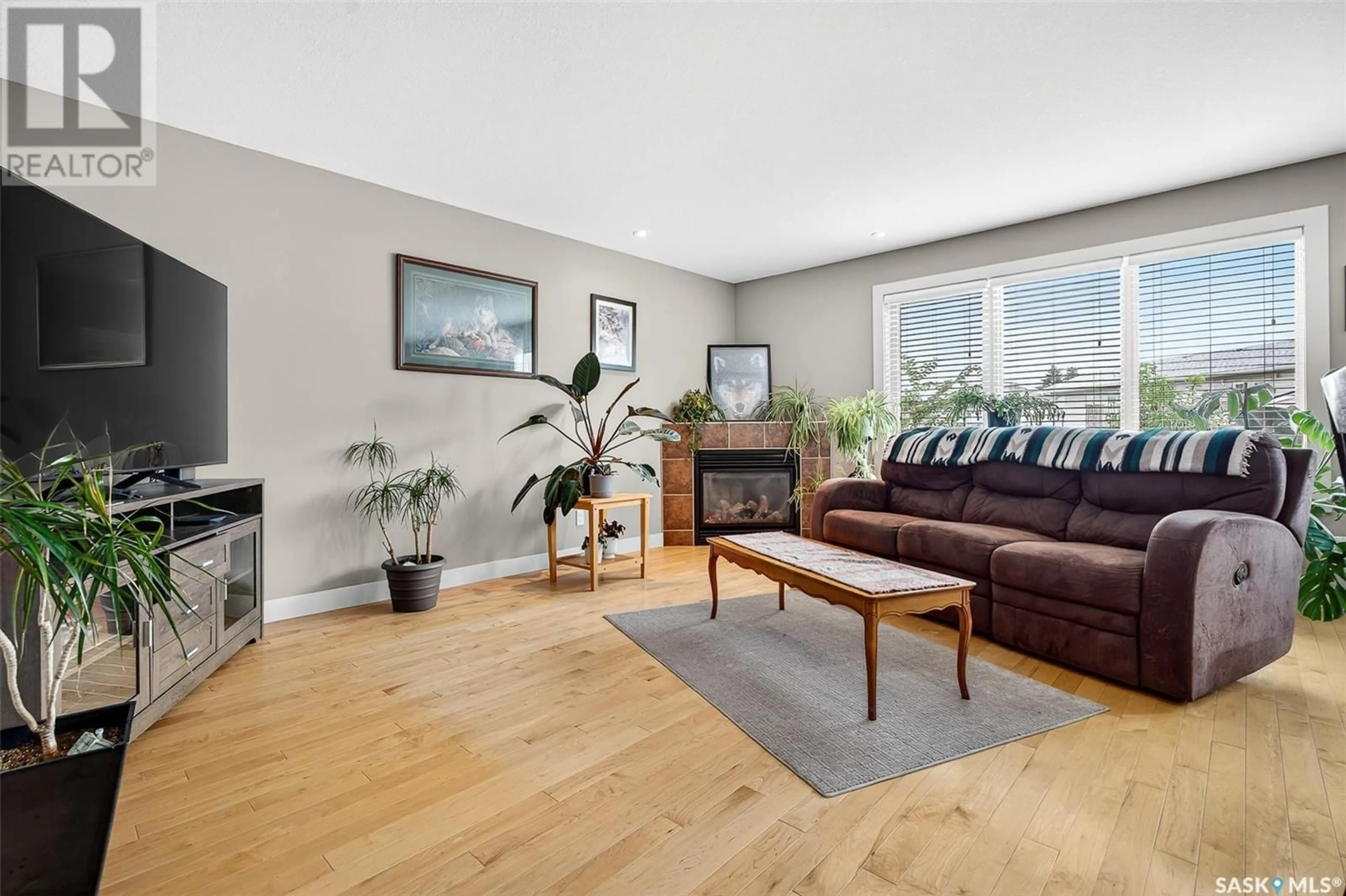 Living room with furniture, wood/laminate floor for 19 EVERTON CRESCENT, Moose Jaw Saskatchewan S6K0A1