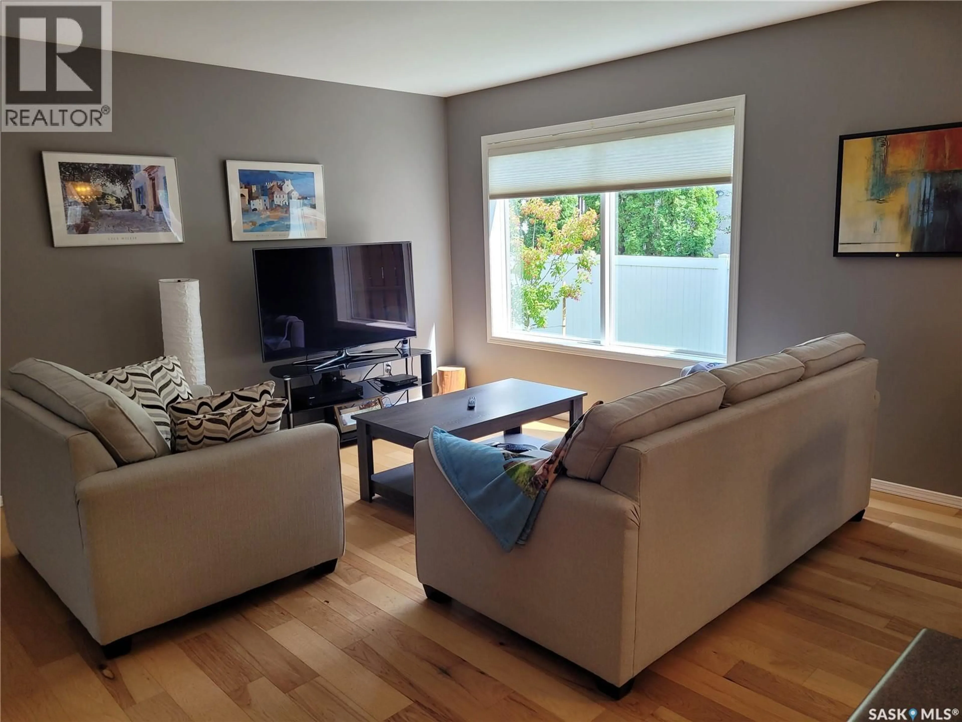 Living room with furniture, wood/laminate floor for 445 - 131 BAYFIELD CRESCENT, Saskatoon Saskatchewan S7V1J1