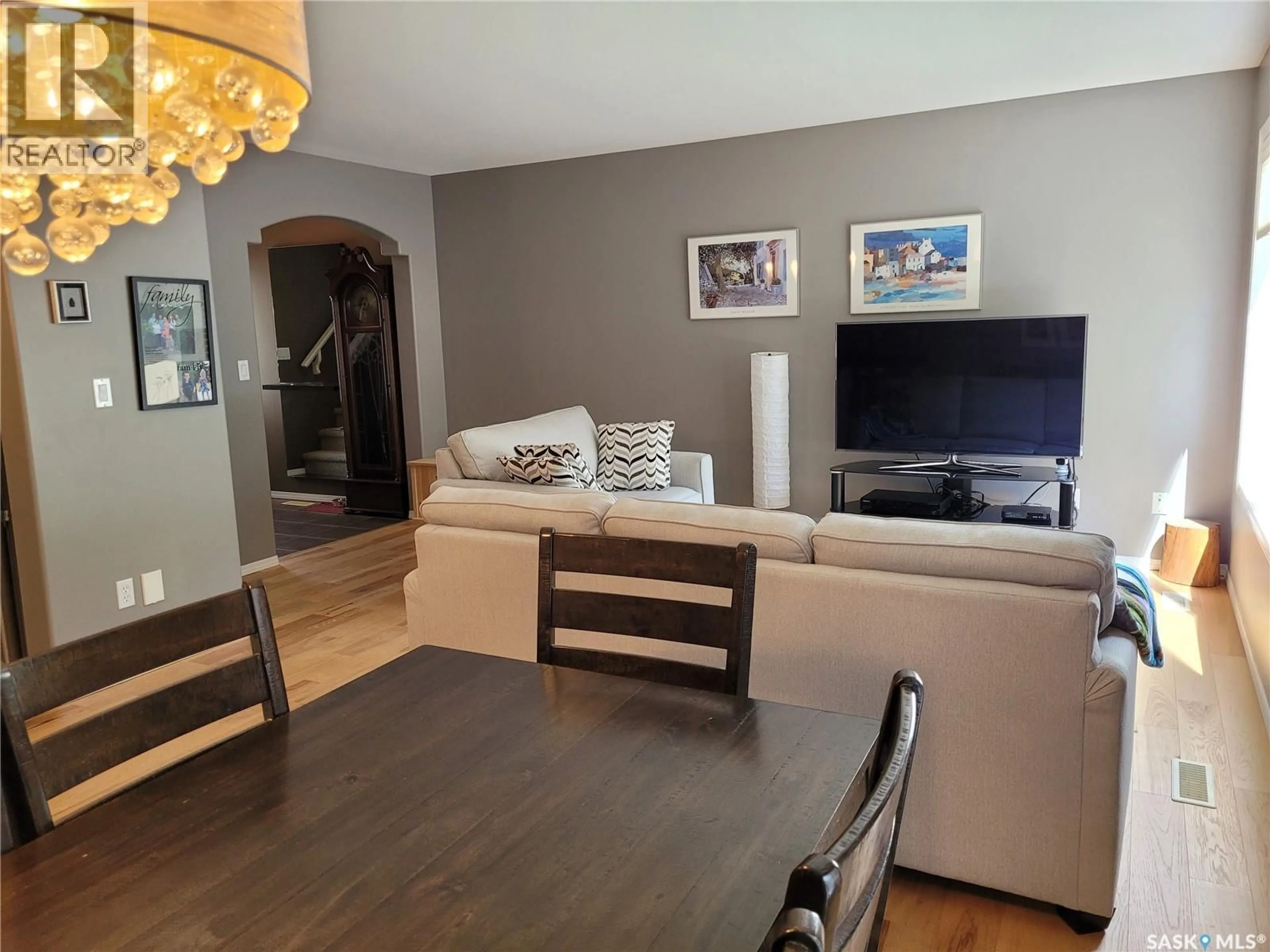 Living room with furniture, wood/laminate floor for 445 - 131 BAYFIELD CRESCENT, Saskatoon Saskatchewan S7V1J1