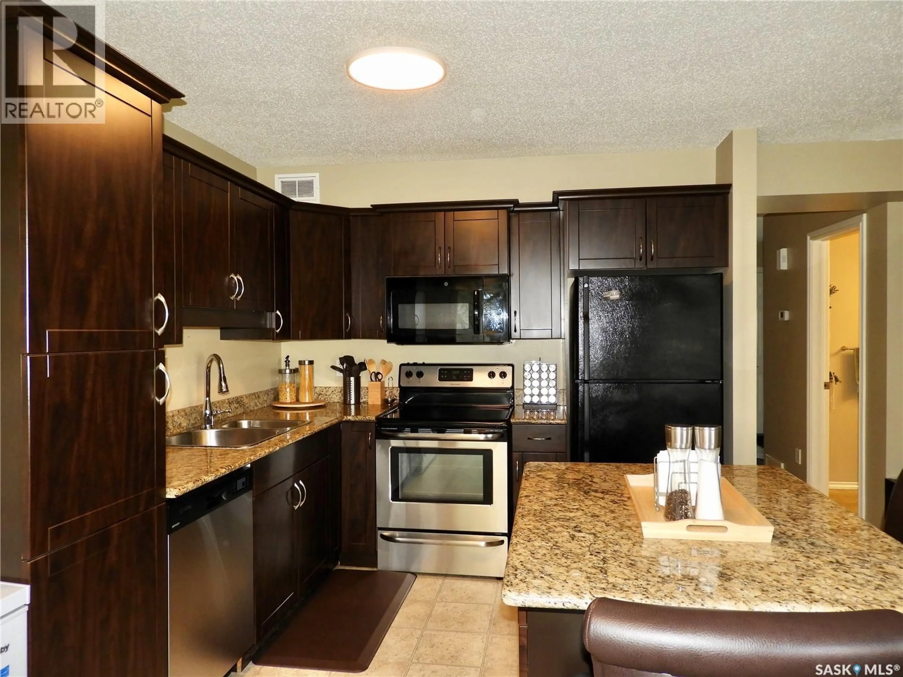 Open concept kitchen, ceramic/tile floor for 105 - 211 LYND CRESCENT, Saskatoon Saskatchewan S7T0C3