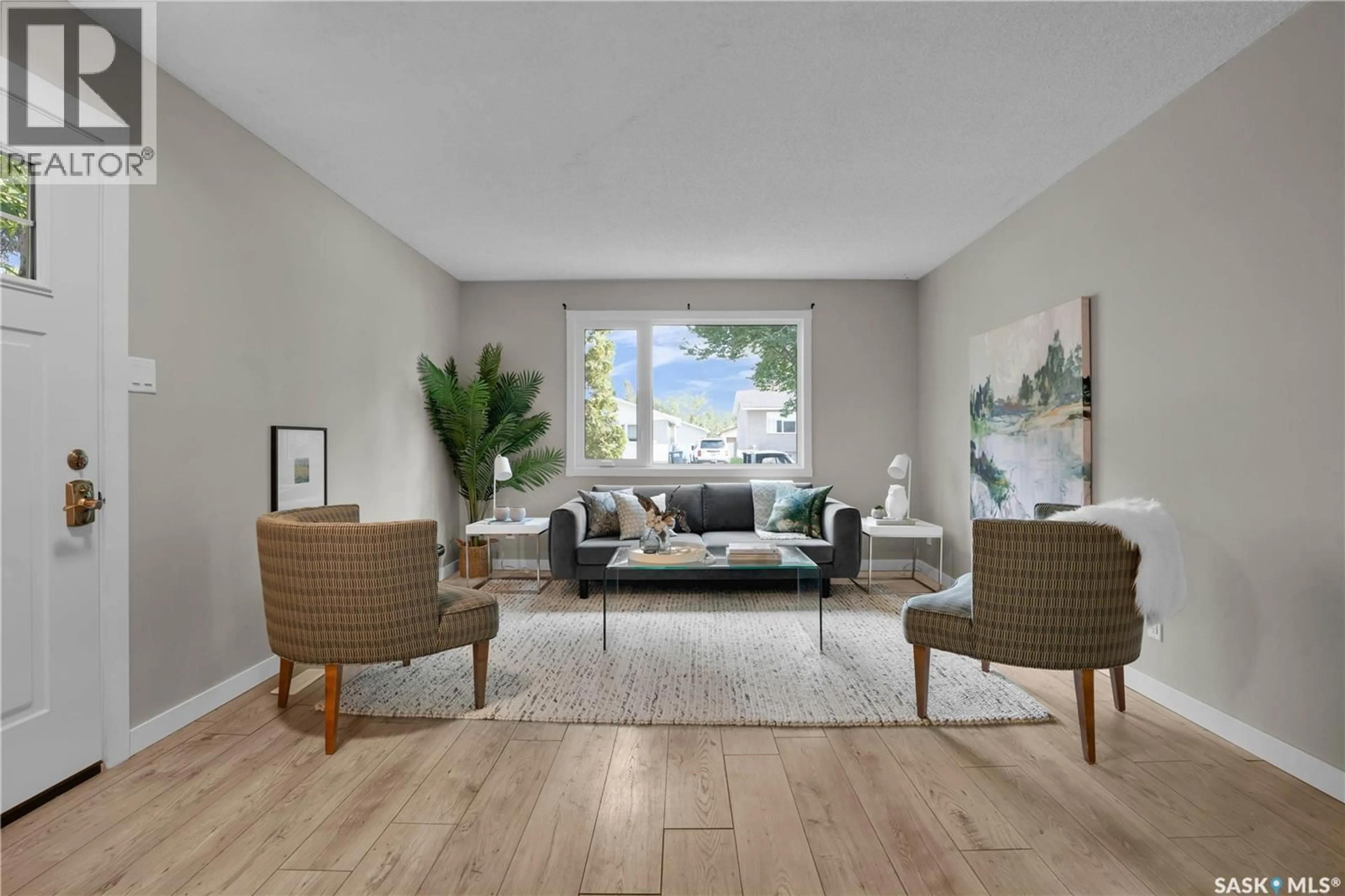 Living room with furniture, wood/laminate floor for 217 WESTERN CRESCENT, Saskatoon Saskatchewan S7H4J5