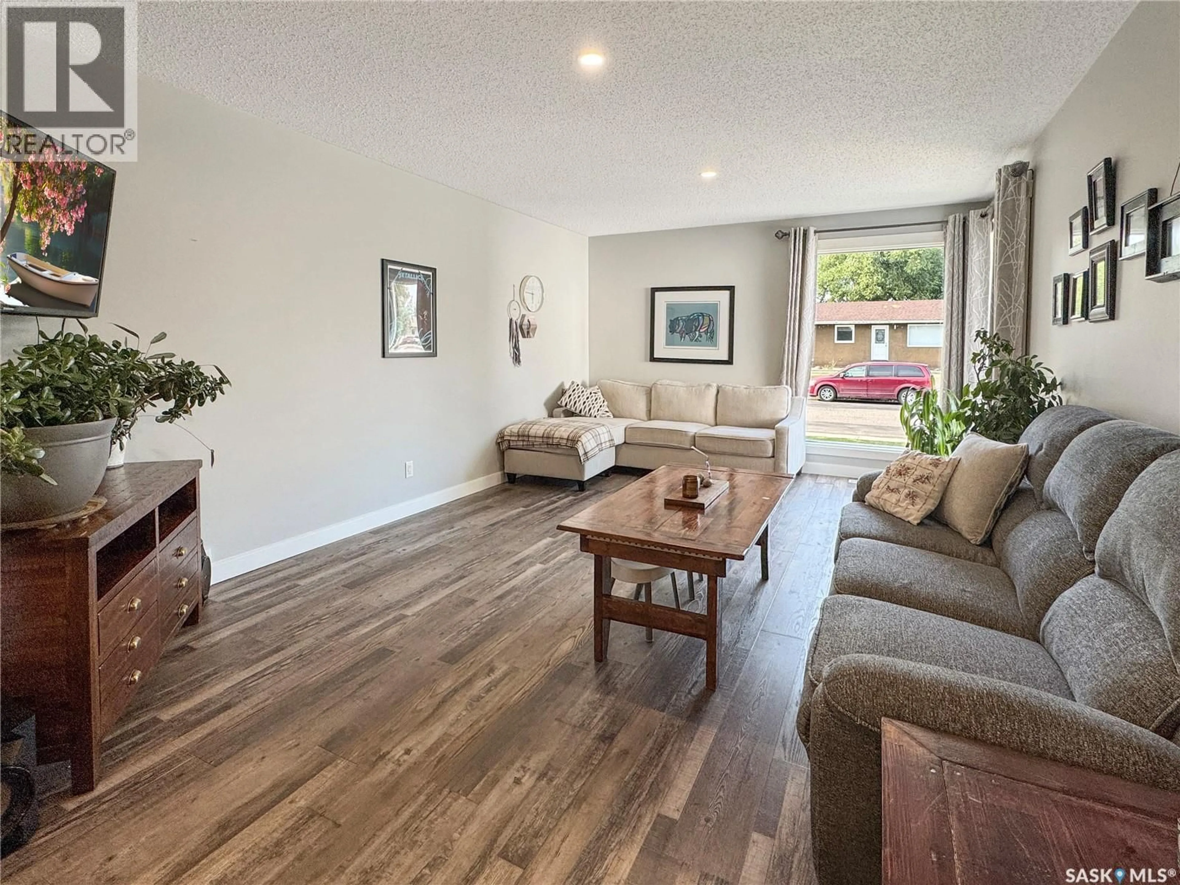 Living room with furniture, wood/laminate floor for 9020 MITCHELL AVENUE, North Battleford Saskatchewan S9A3J7
