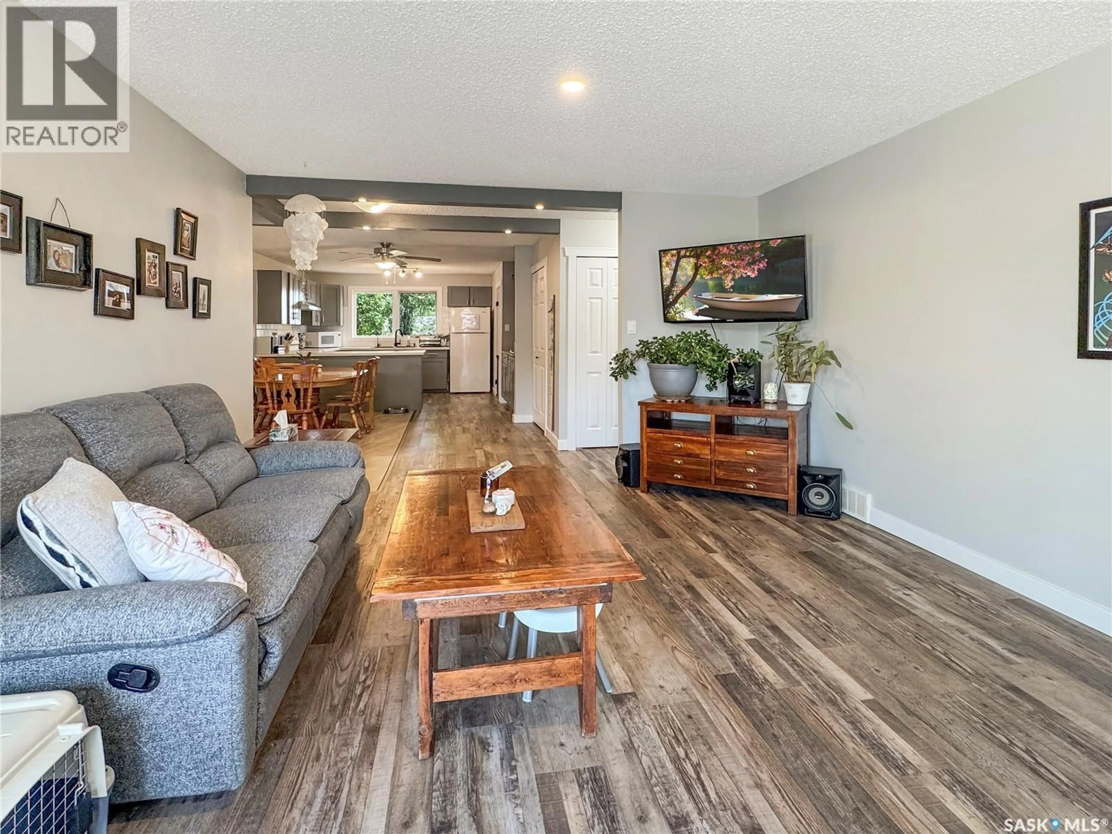 Living room with furniture, wood/laminate floor for 9020 MITCHELL AVENUE, North Battleford Saskatchewan S9A3J7